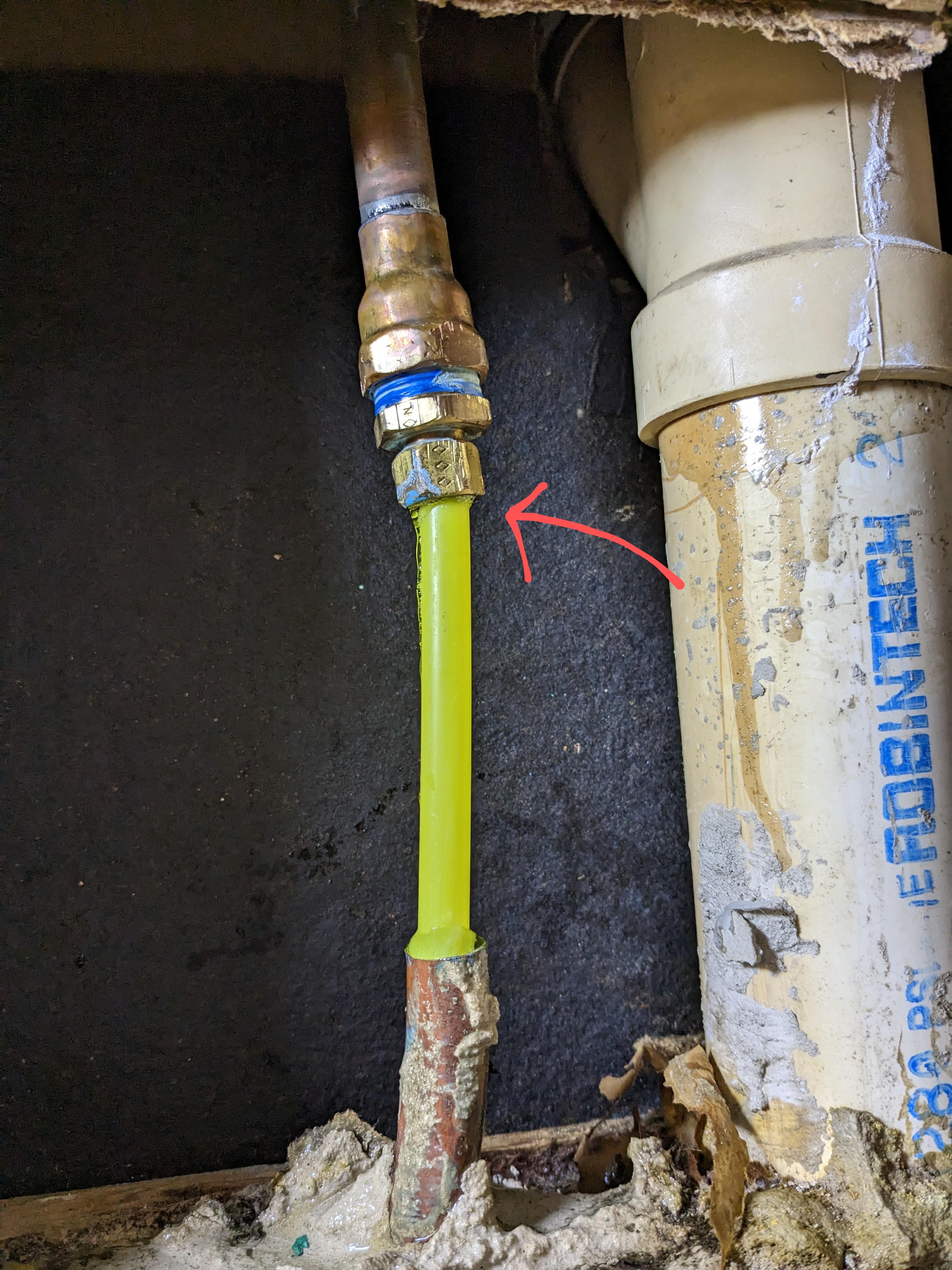 water is sleeping out where the yellow plastic pipe enters the metal