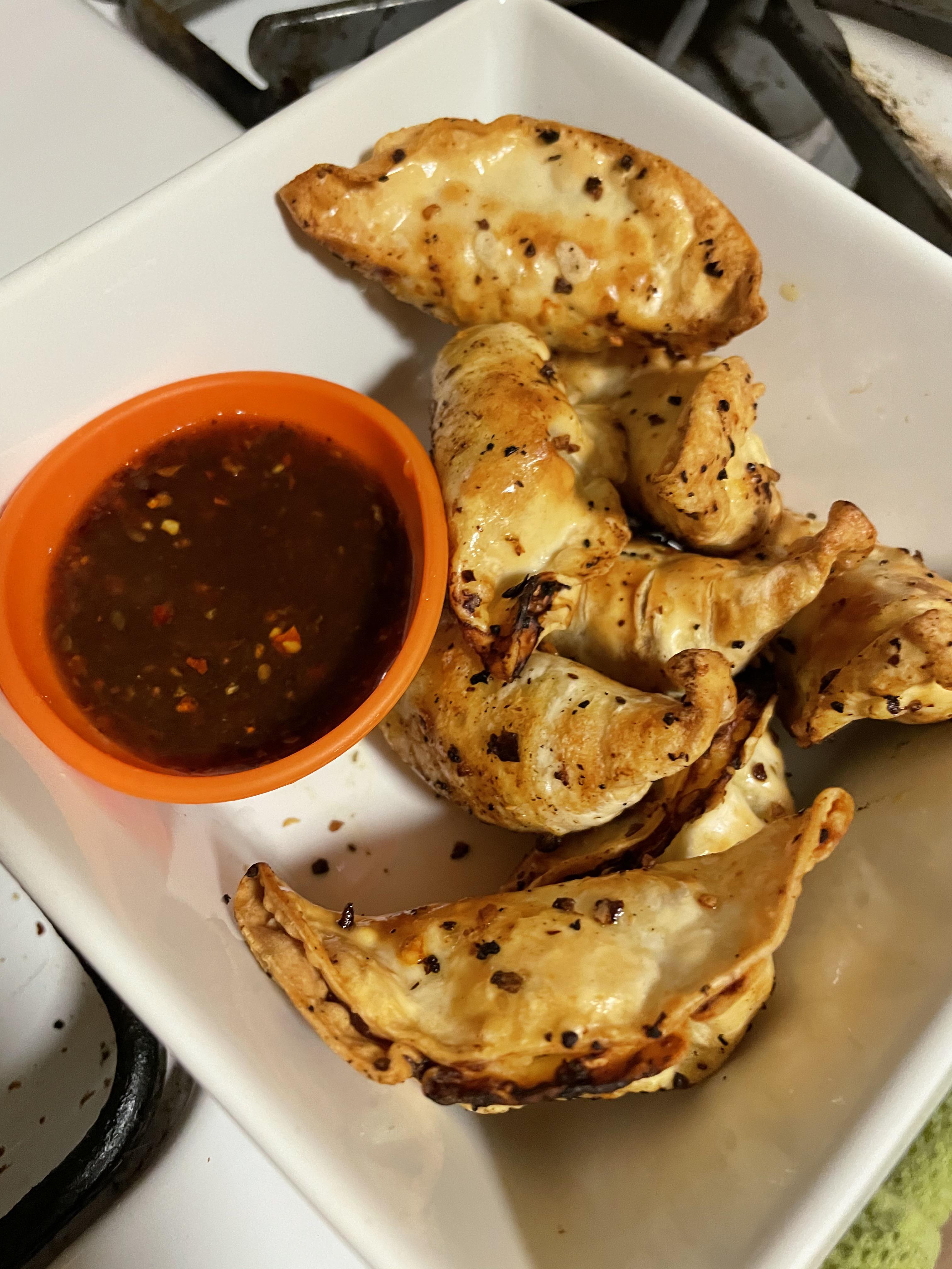 Air fried Chicken Gyoza Potstickers tossed in Chili Garlic Crunch, side