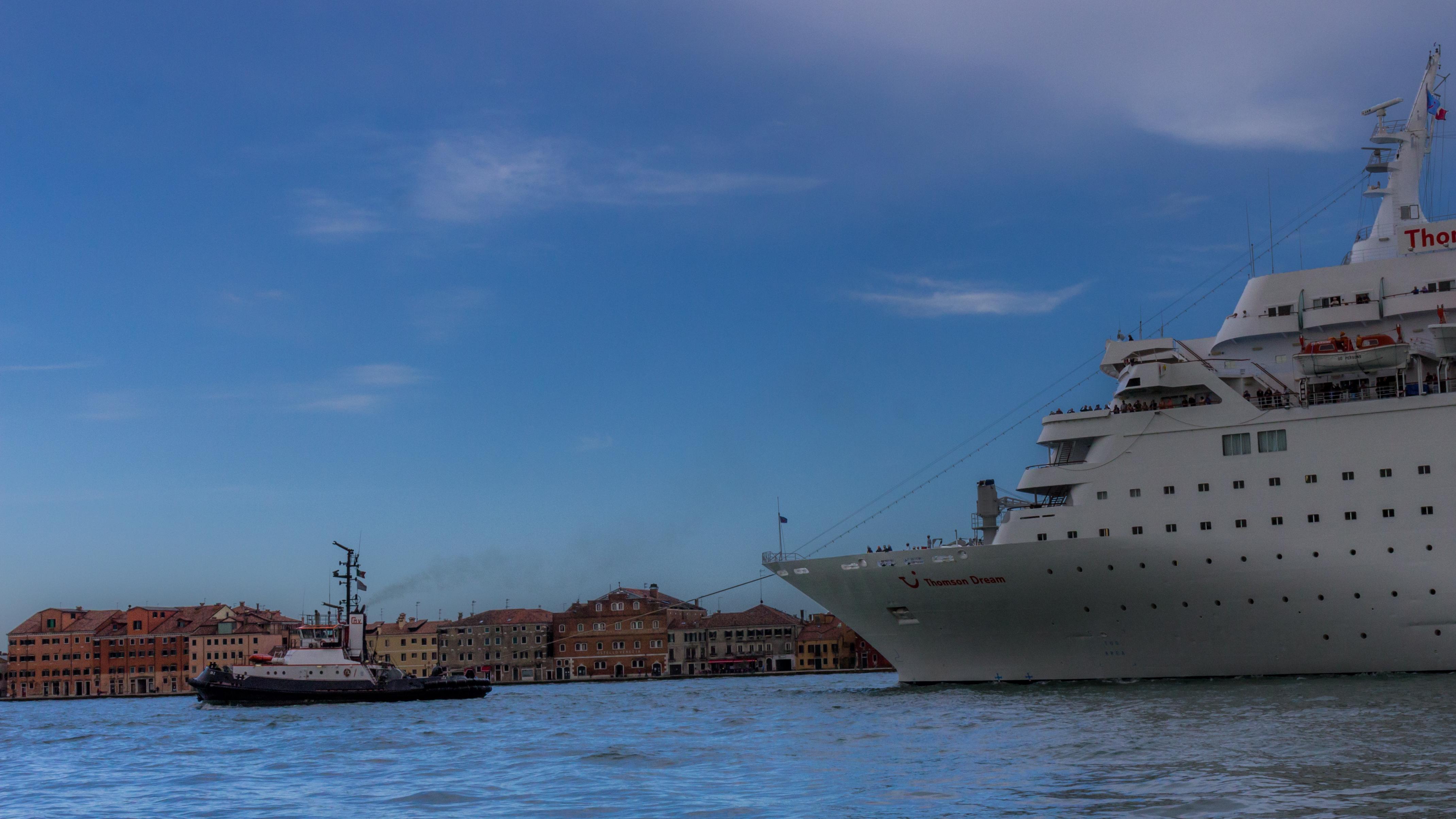 A cruise ship in Venice being towed back out to sea
