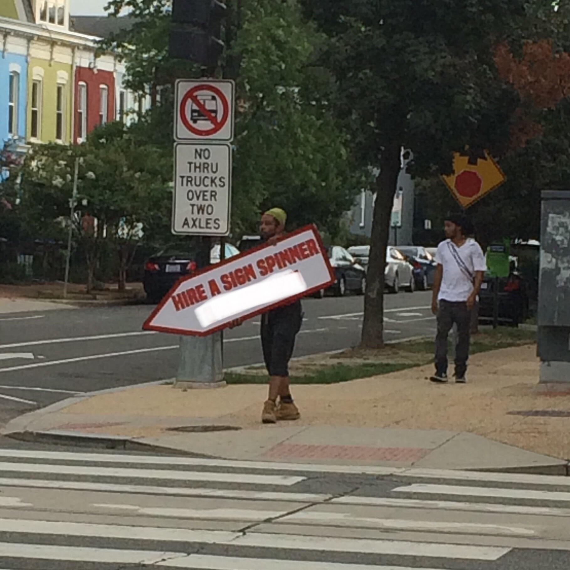 This sign spinner advertising sign spinners. r/mildlyinteresting
