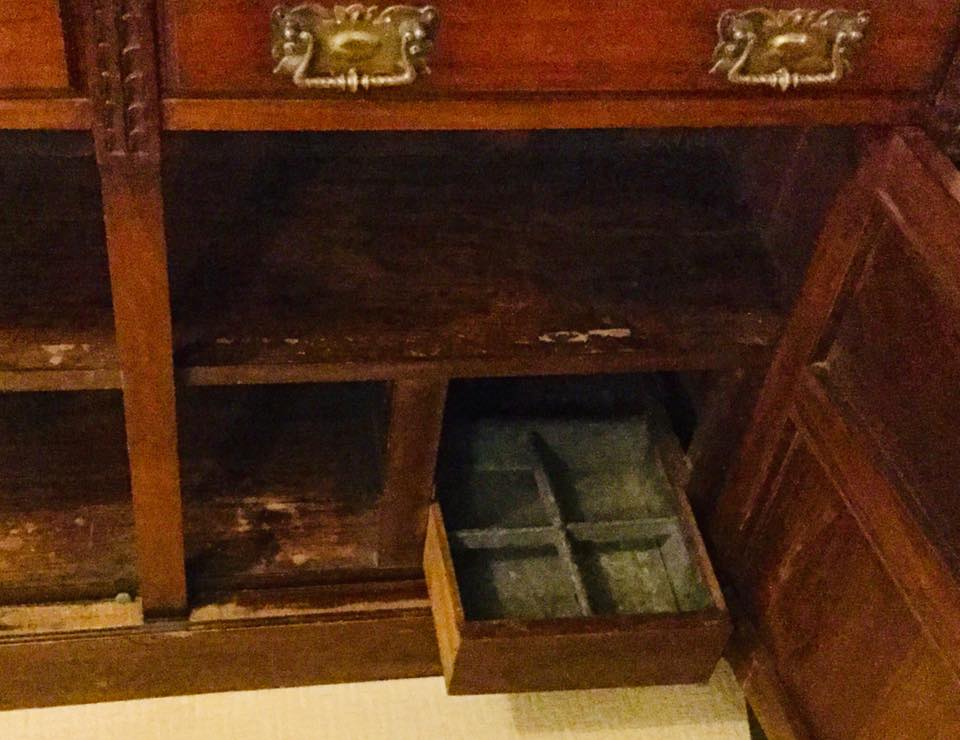 A friend bought an Antique Dresser. There is a bottom drawer which