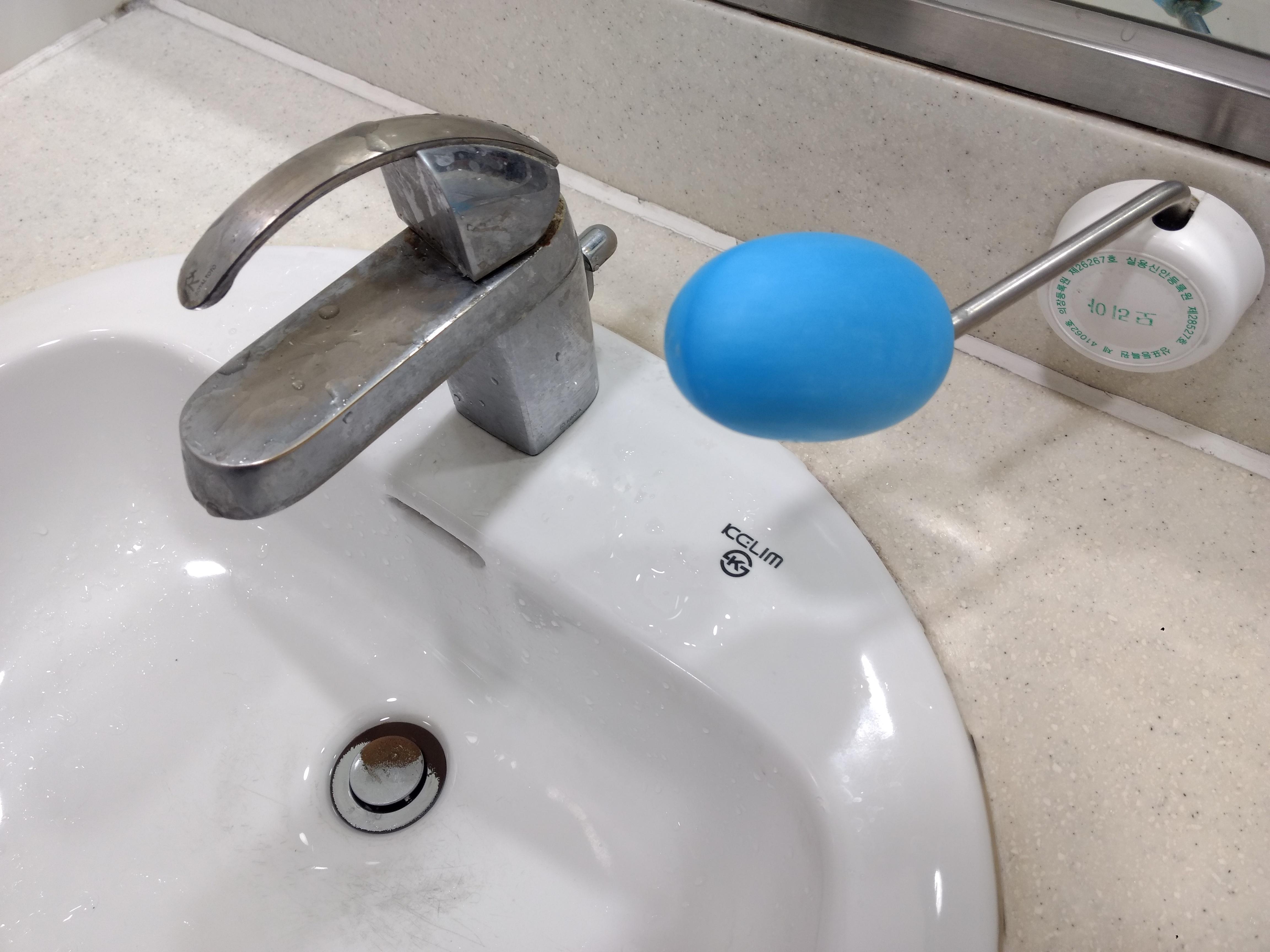 This bathroom in Korea has bars of soap on sticks next to the sinks