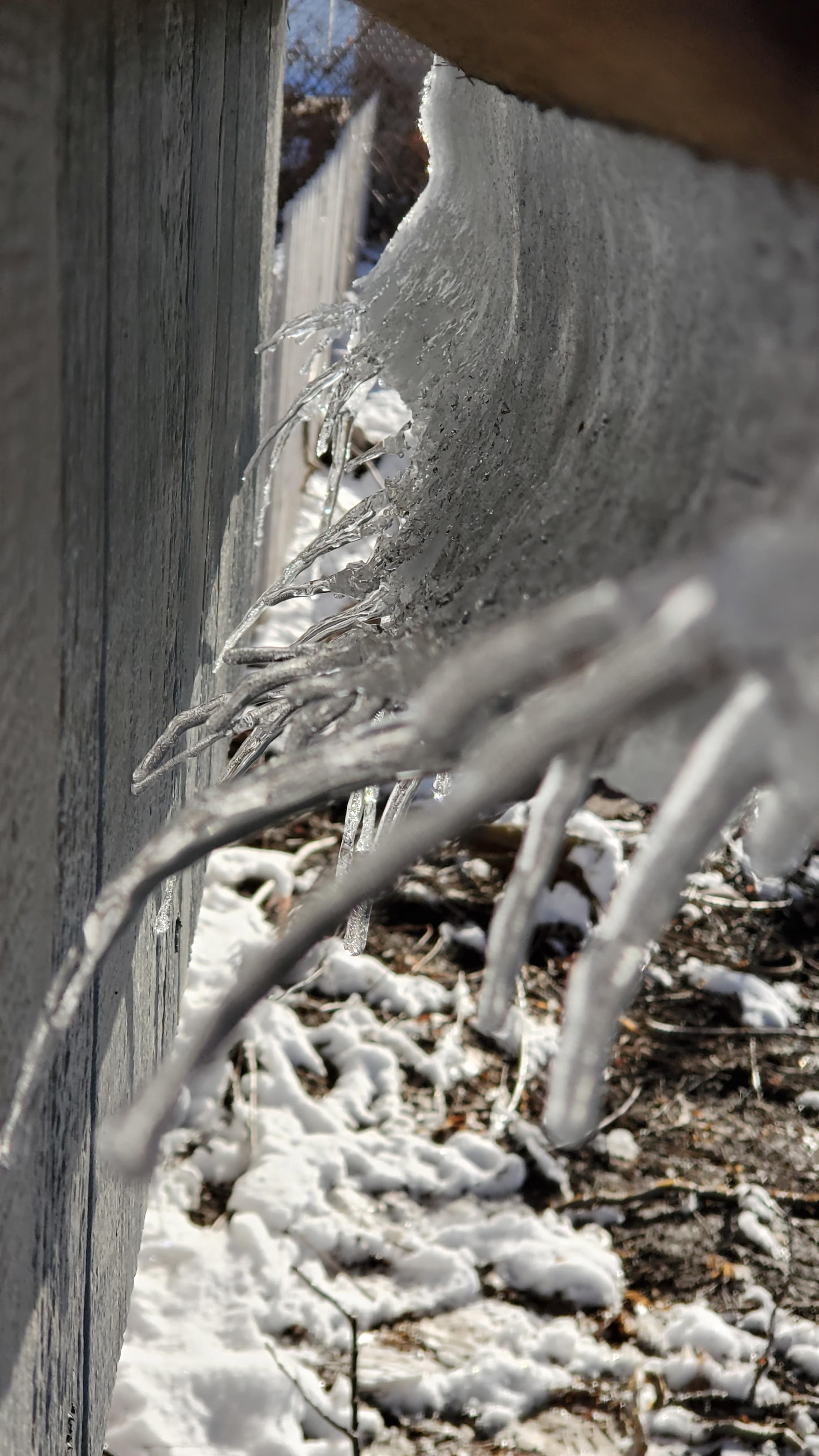 Snow curling off my chicken coop roof r/mildlyinteresting