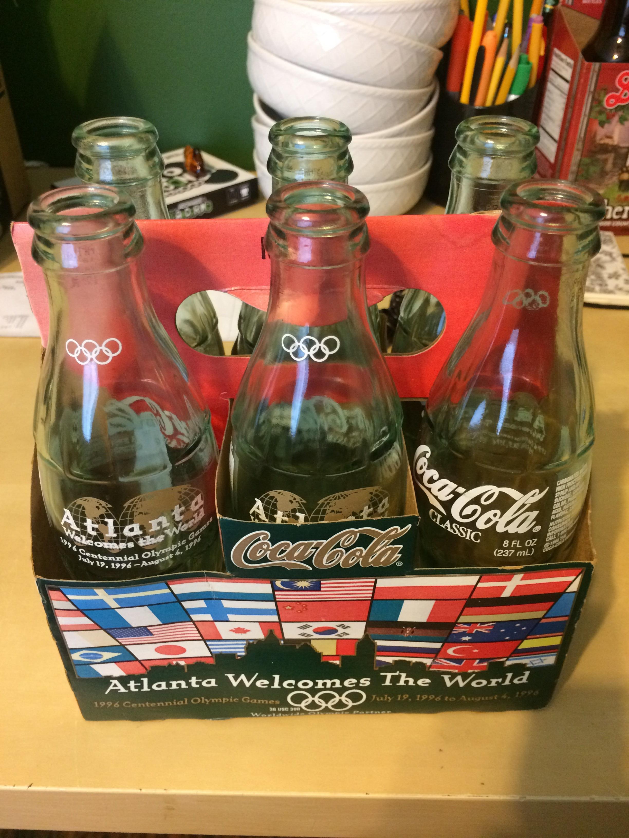 A set of 1996 Olympic Coke bottles including the case r/ThriftStoreHauls
