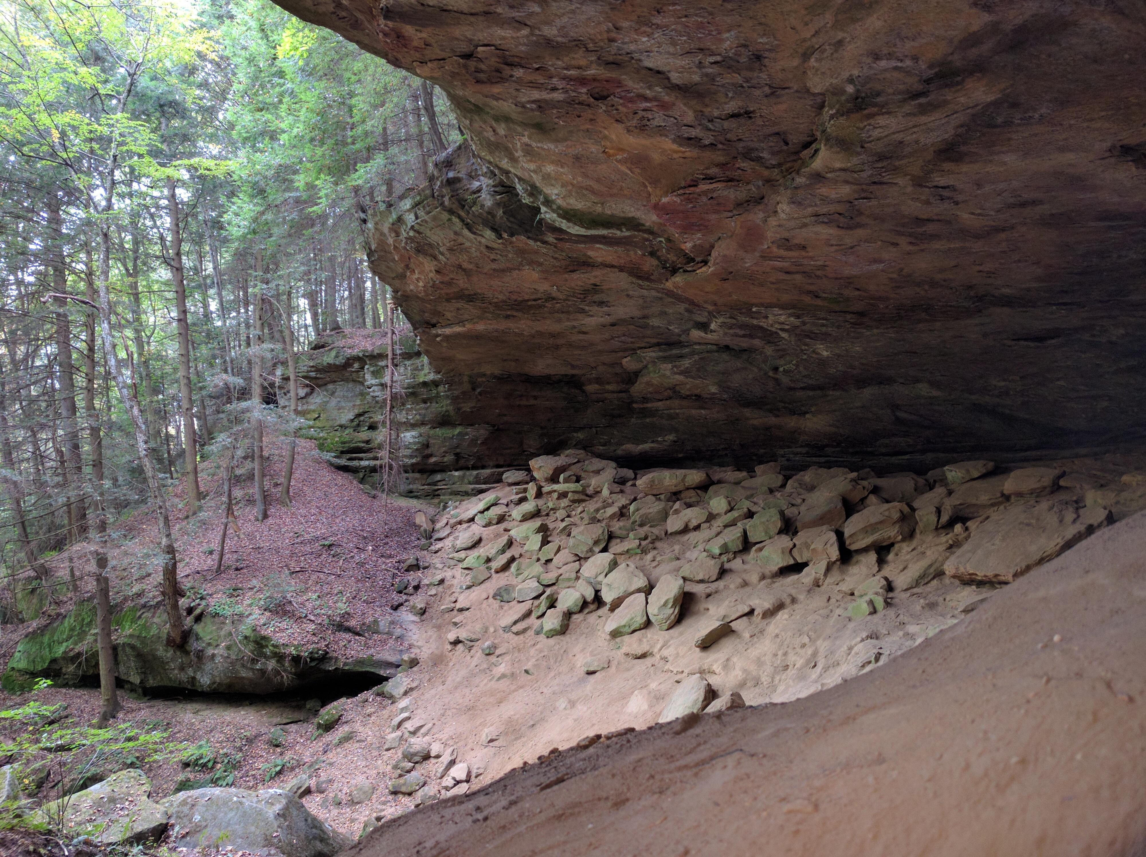 Natural sandstone cave nestled into the hemlockcovered hills of