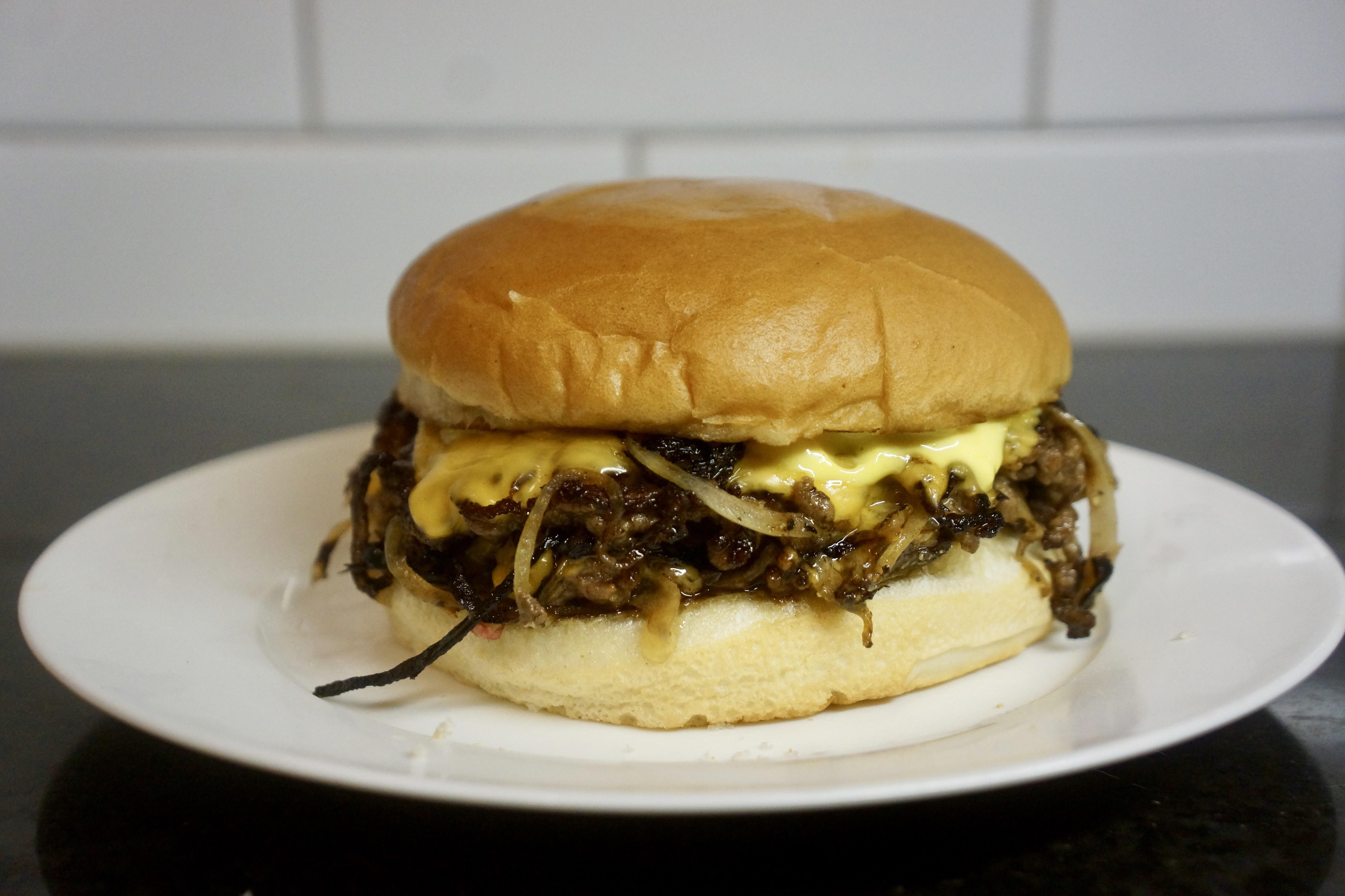 Oklahoma style fried onion smashed cheeseburger with pickles and