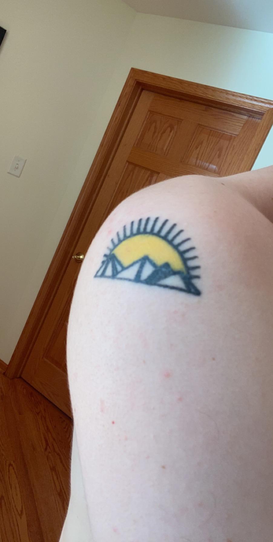 tattoo just under a year old. on left arm/shoulder. can i