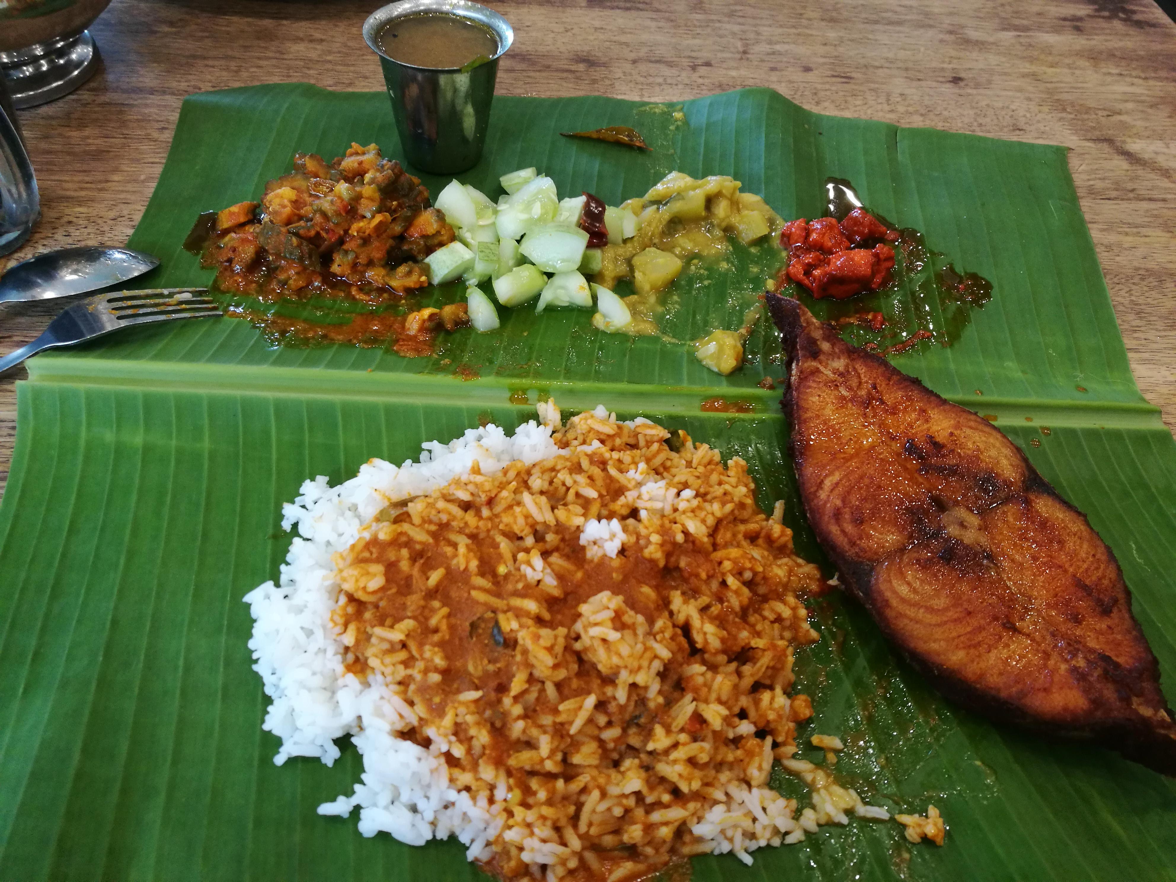 [I ate] Banana leaf meal of rice, vegetables, fried tenggiri fish, and