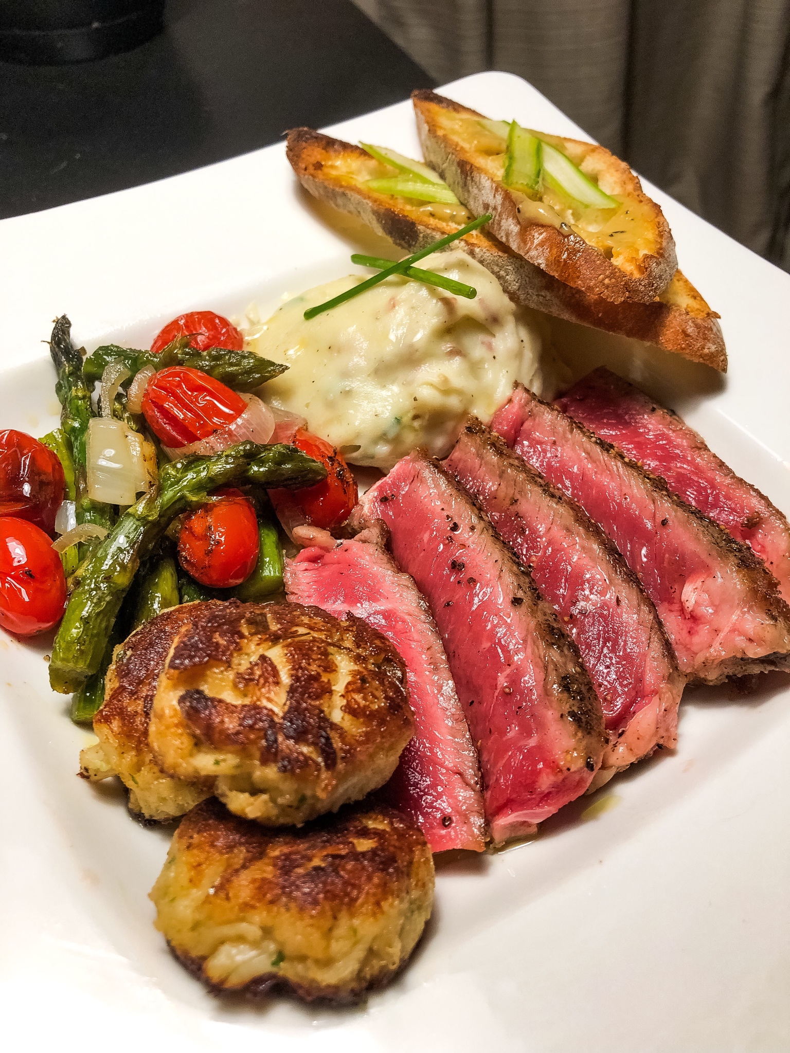 Ribeye with crab cakes, garlic mashed potatoes, roasted asparagus w