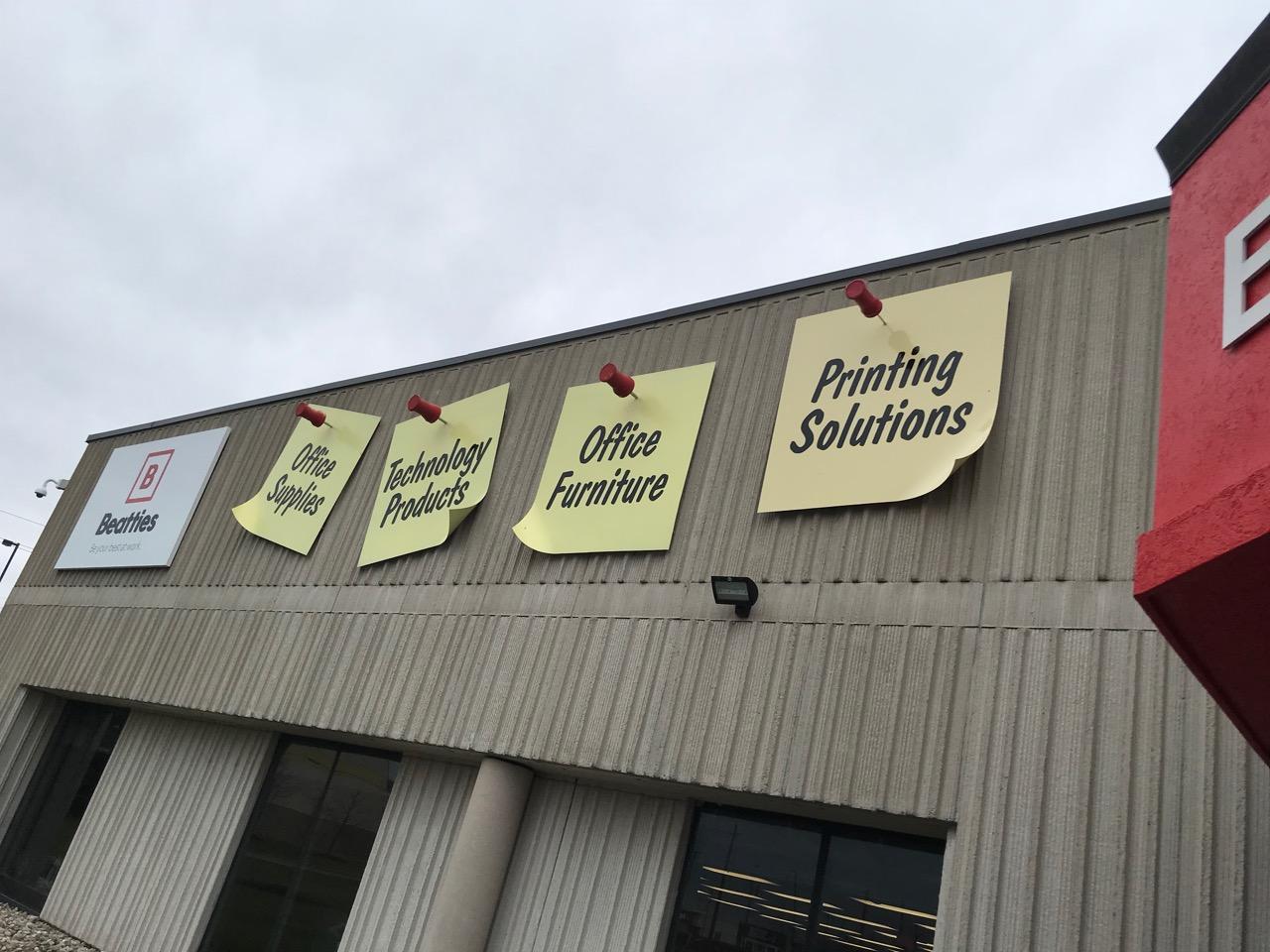 This office supply store's sign is sticky notes and push pins r