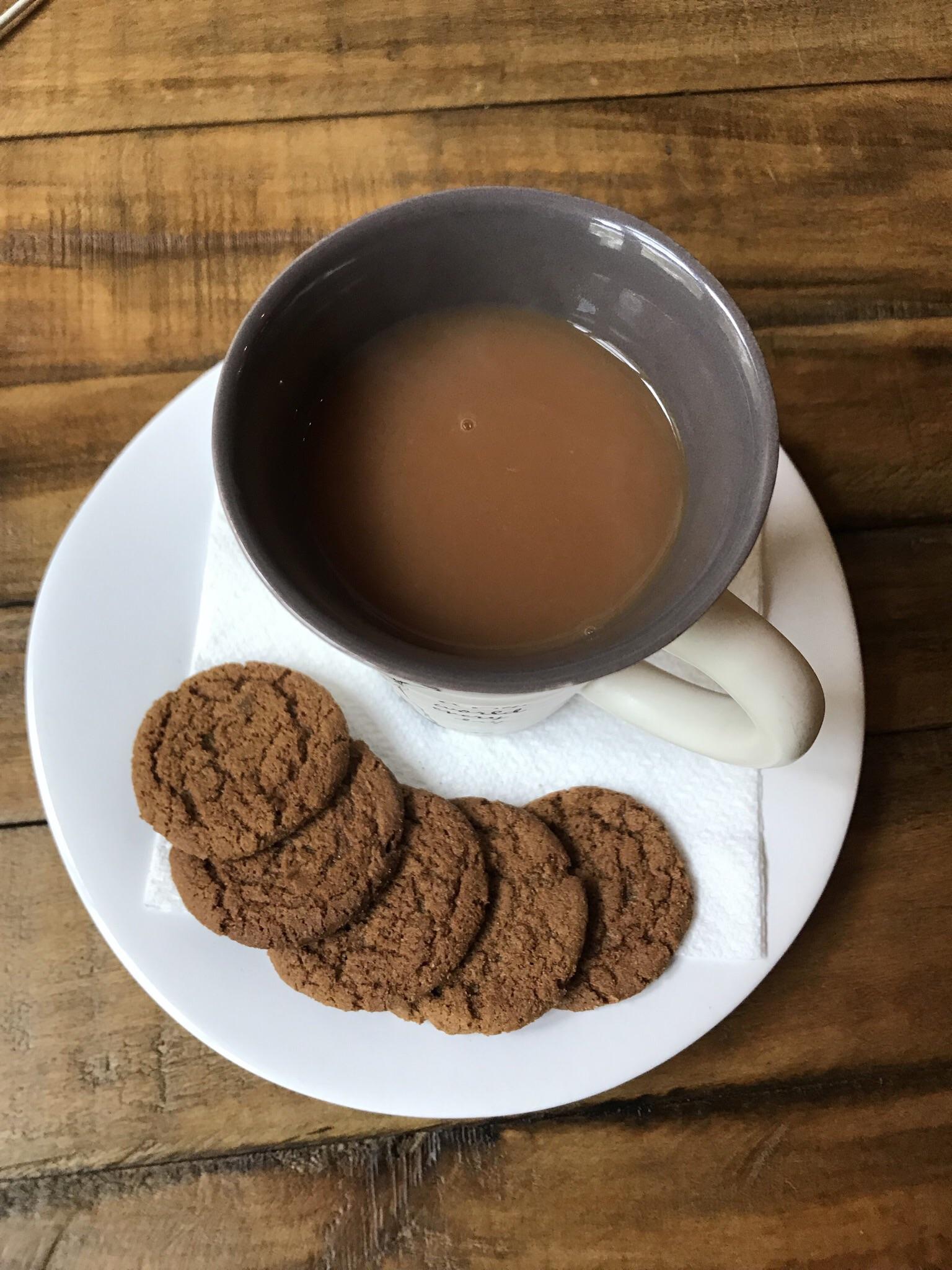 English breakfast with a splash of almond milk and some ginger snaps