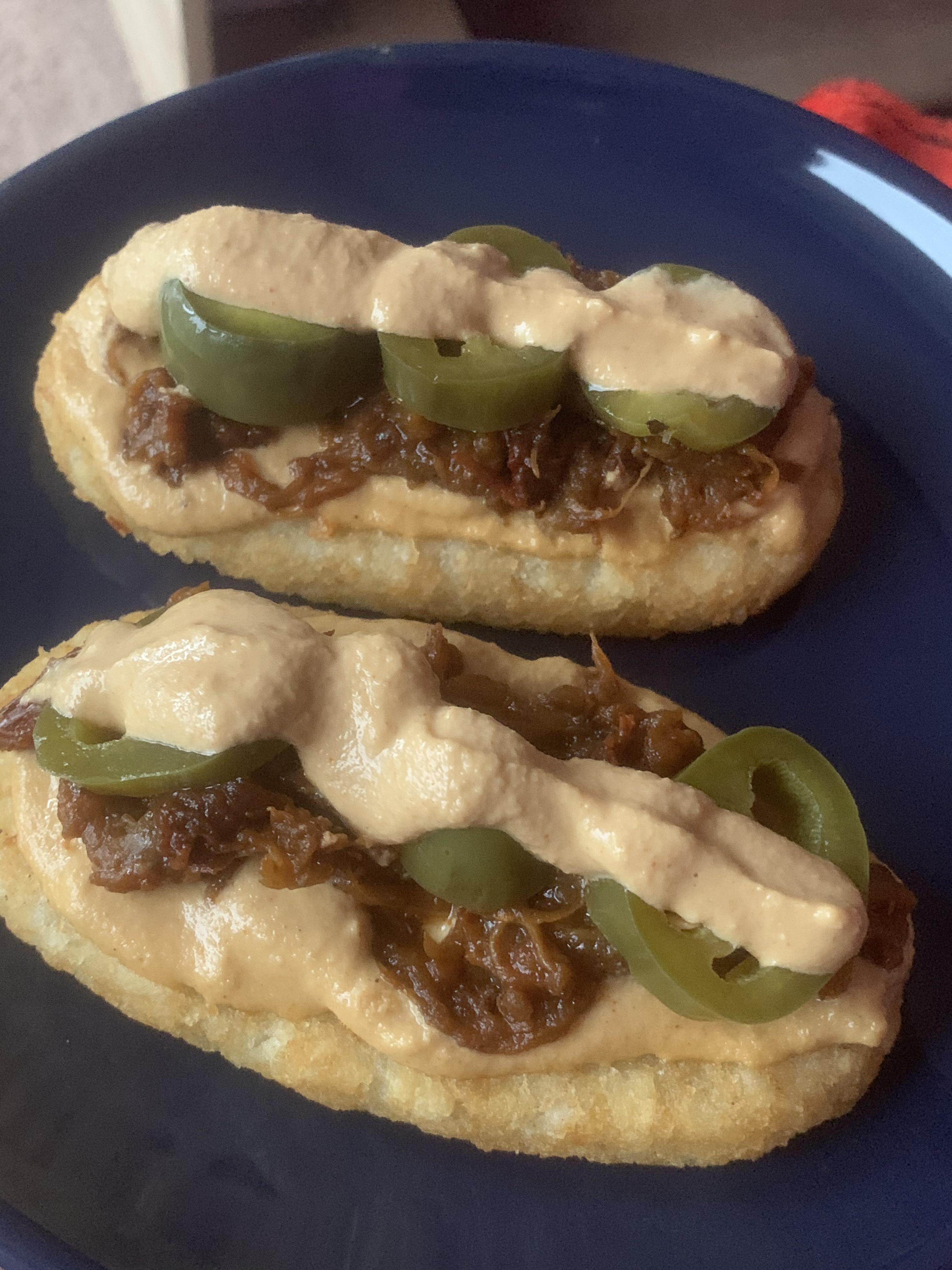 Air fried hash browns, eggplant pulled pork, nacho cheese, & homemade