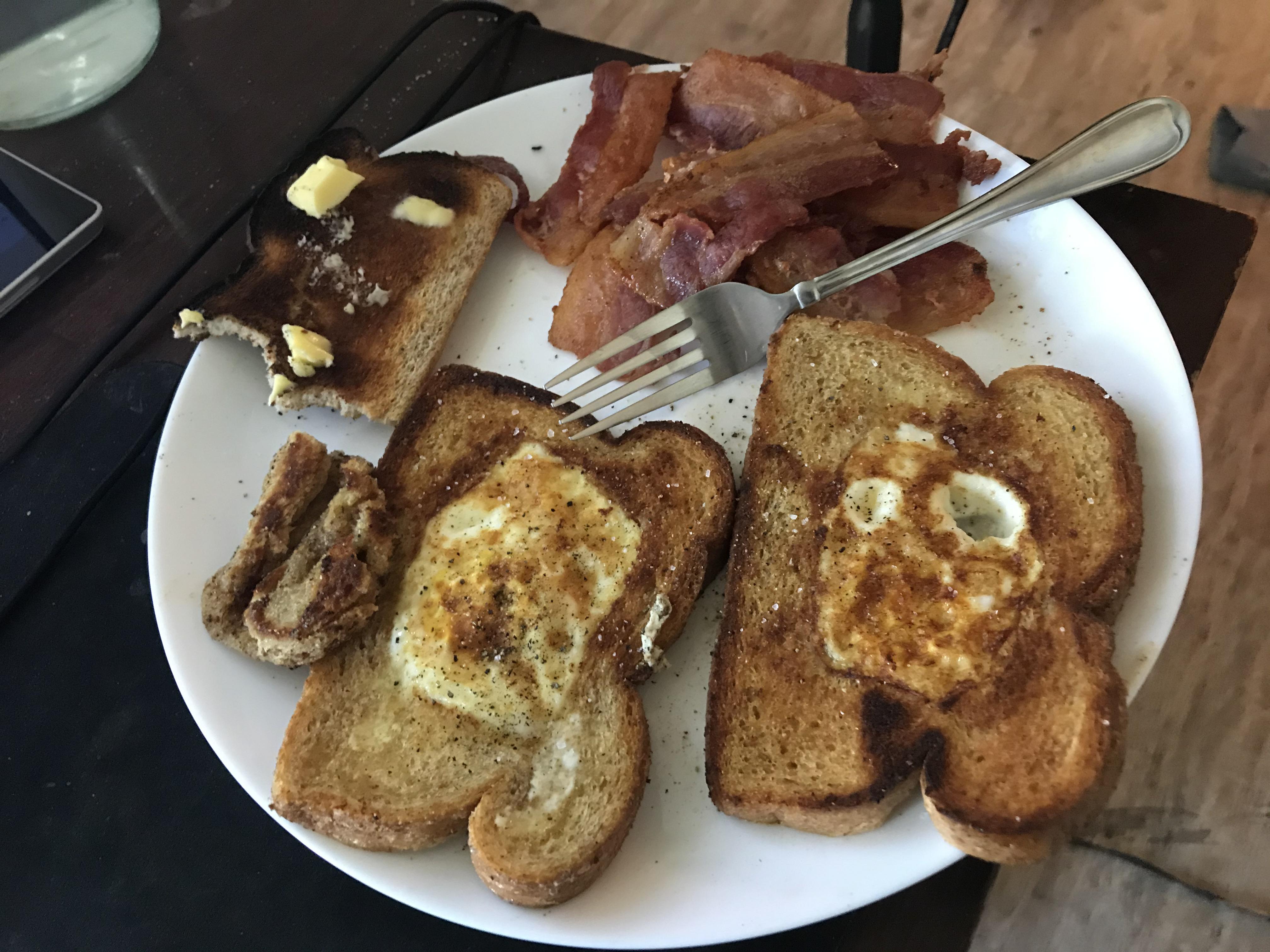 Egg in a basket w/ a side of burnt toast & 10 pieces of bacon r