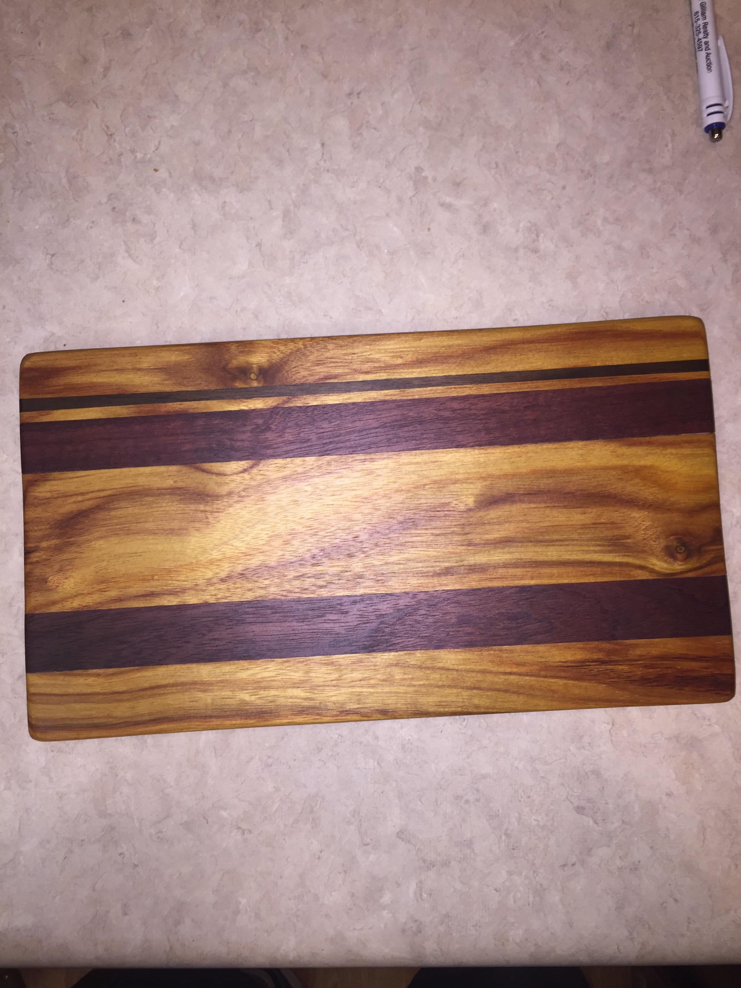 First cutting board Purpleheart, canary wood, and black walnut r/woodworking