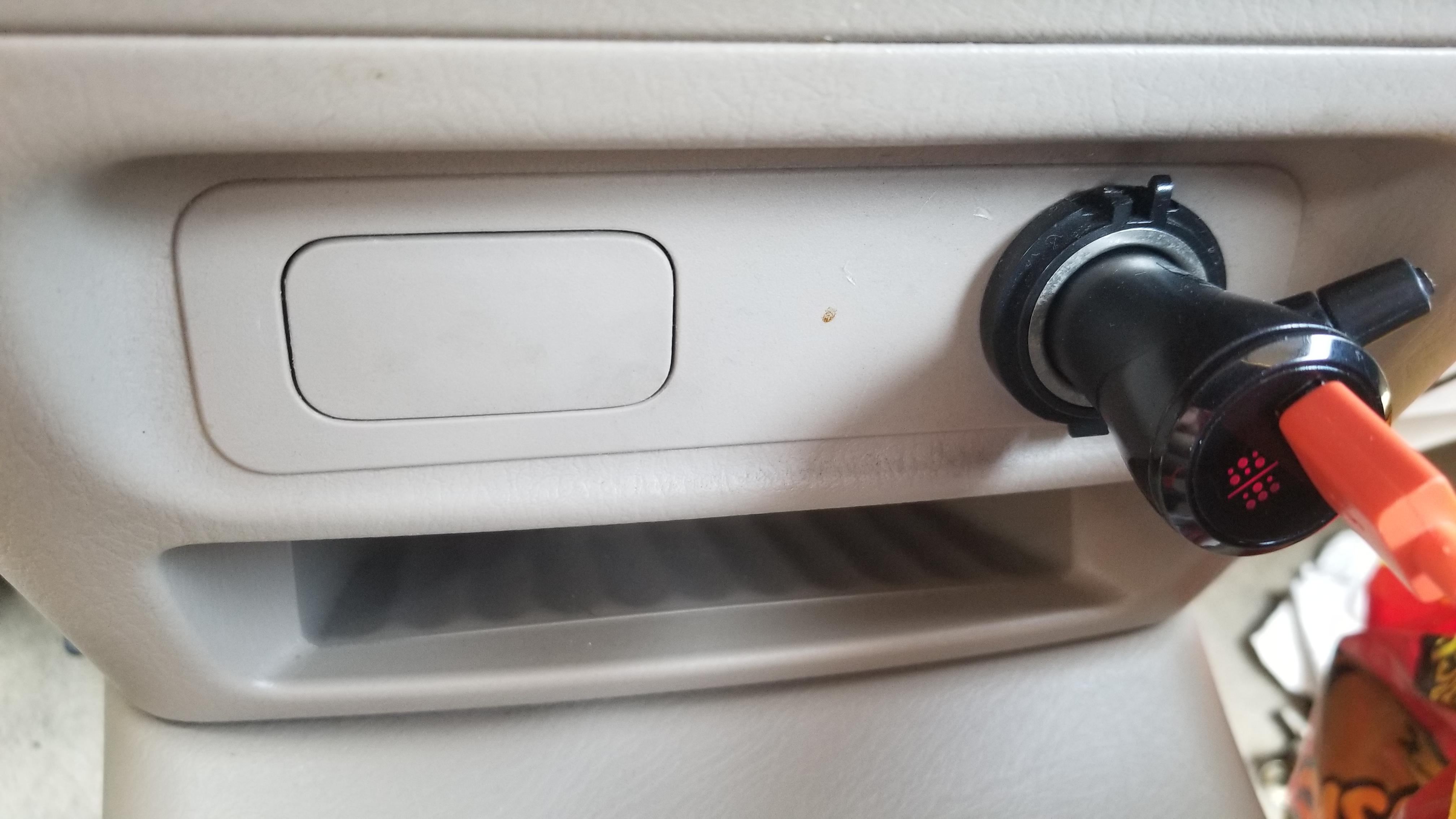 Small panel next to cigarette lighter in a 2001 Honda Civic. It seems