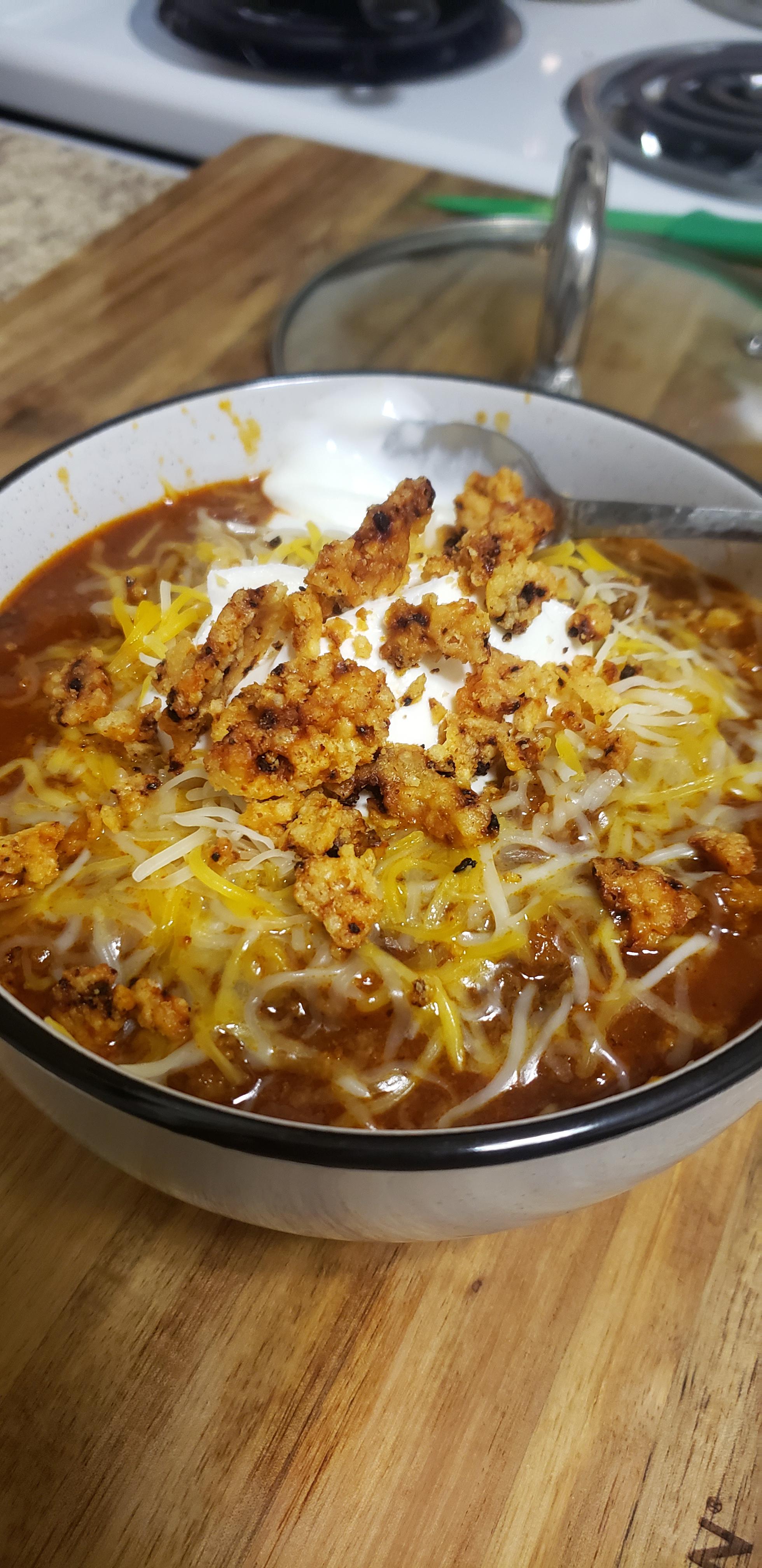 Spicy Keto Chili w/ shredded cheese, sour cream, and crushed parmesan