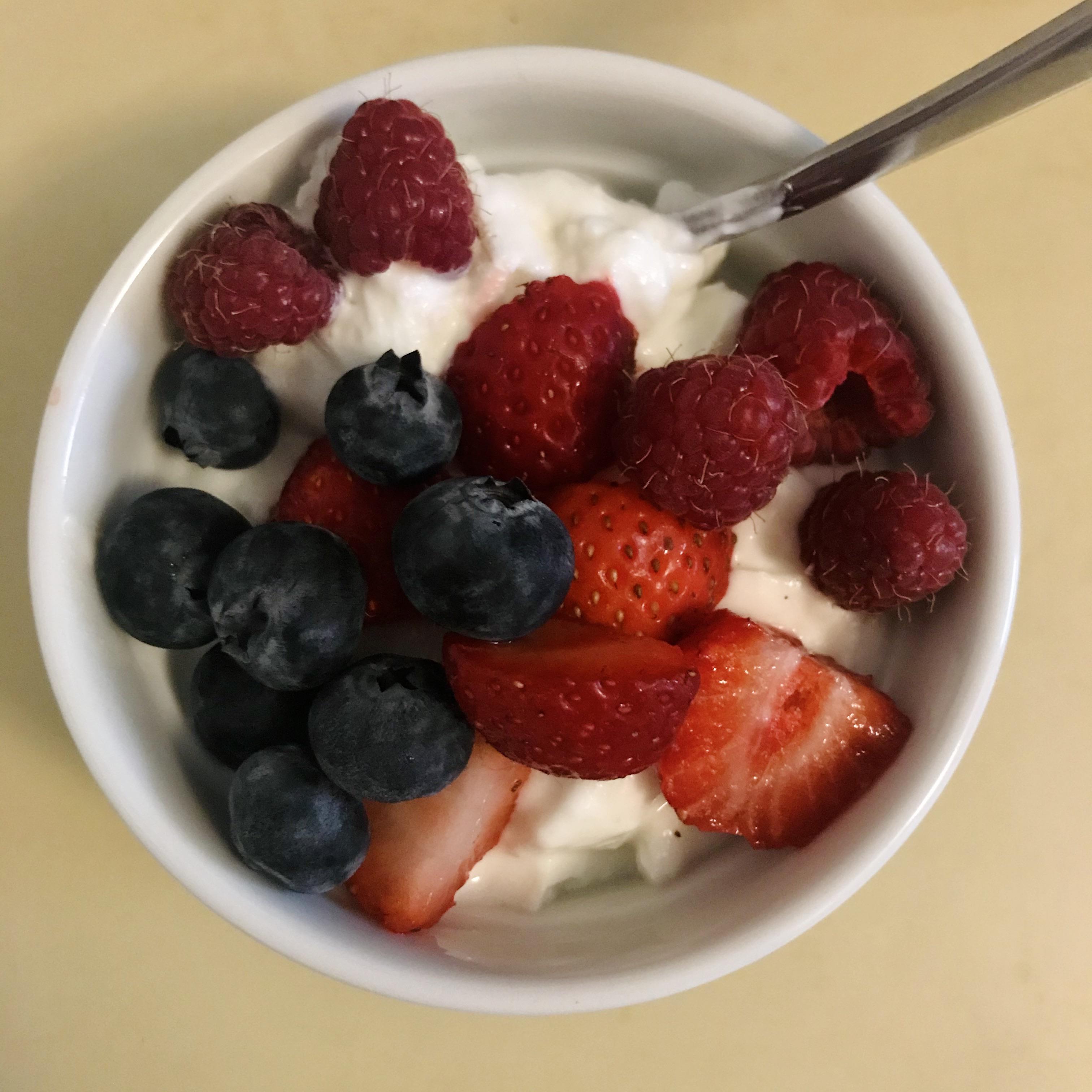 Plain 0 Greek Yogurt with gardengrown raspberries, local strawberries