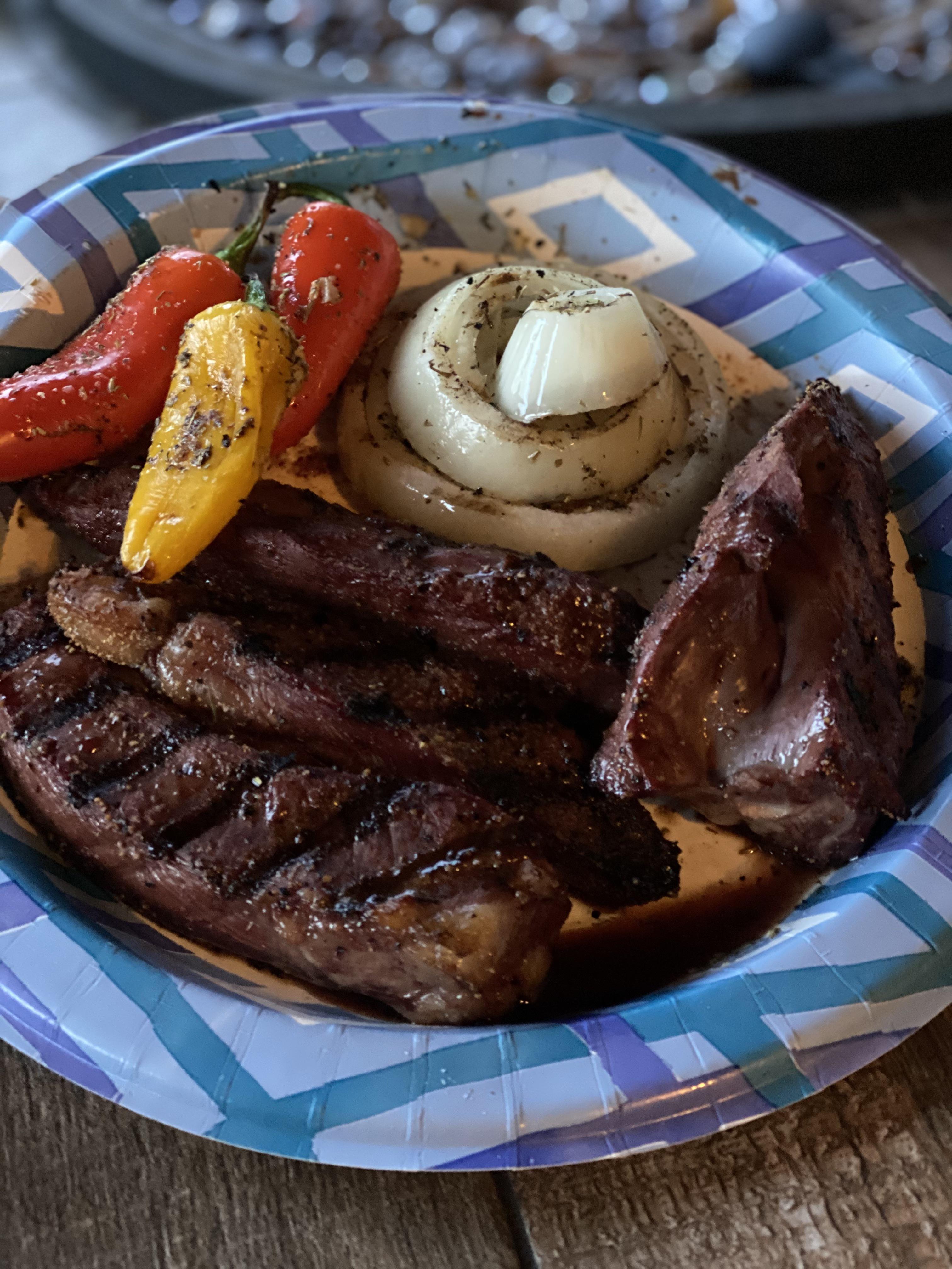 Veal beef heart with roasted mini peppers and onions on the Traeger r