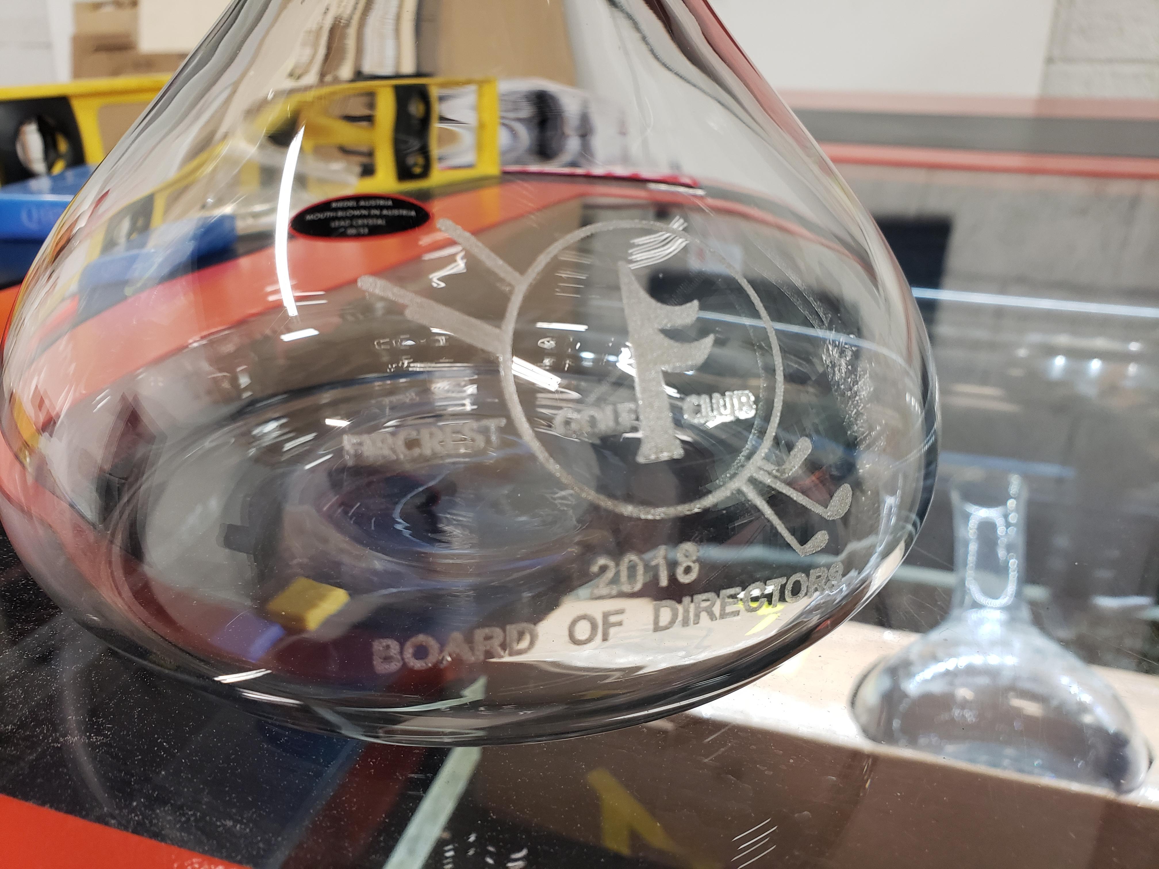 Laser engraved some wine decanters, it was a pain tbh. Domed surface in