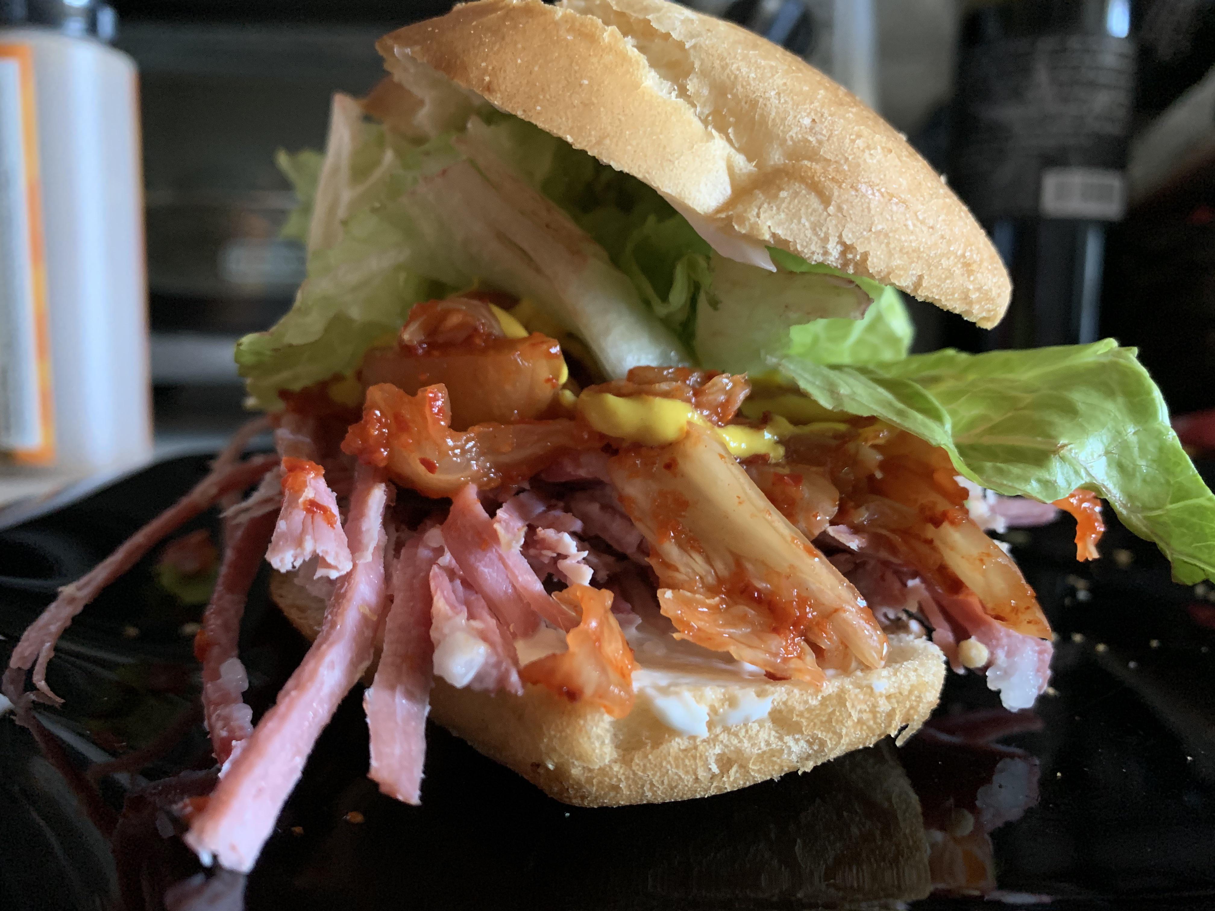 Corned beef and kimchi with romaine lettuce, yellow mustard and mayo on