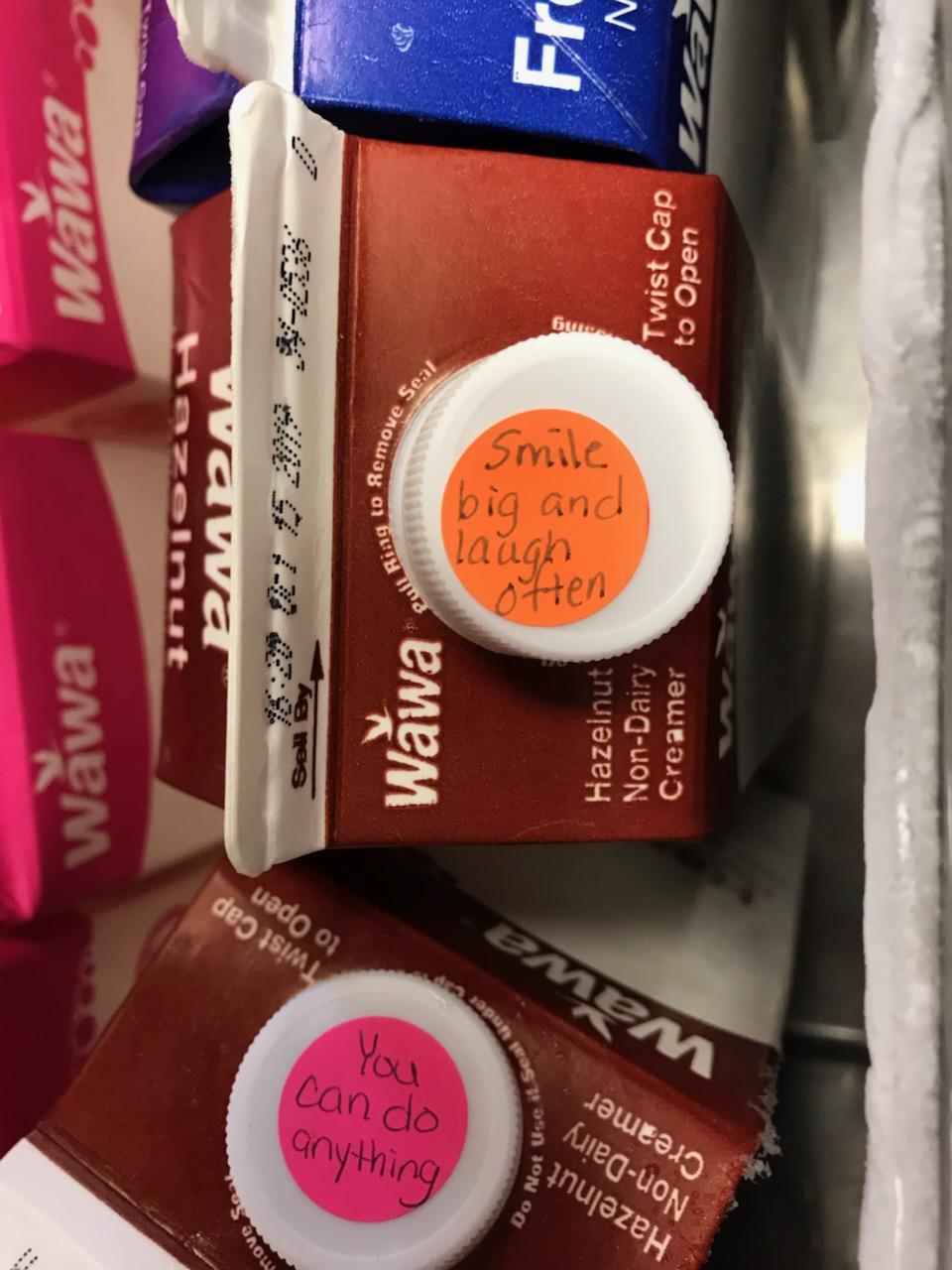 Positive thoughts on coffee creamer lids at our local convenience store