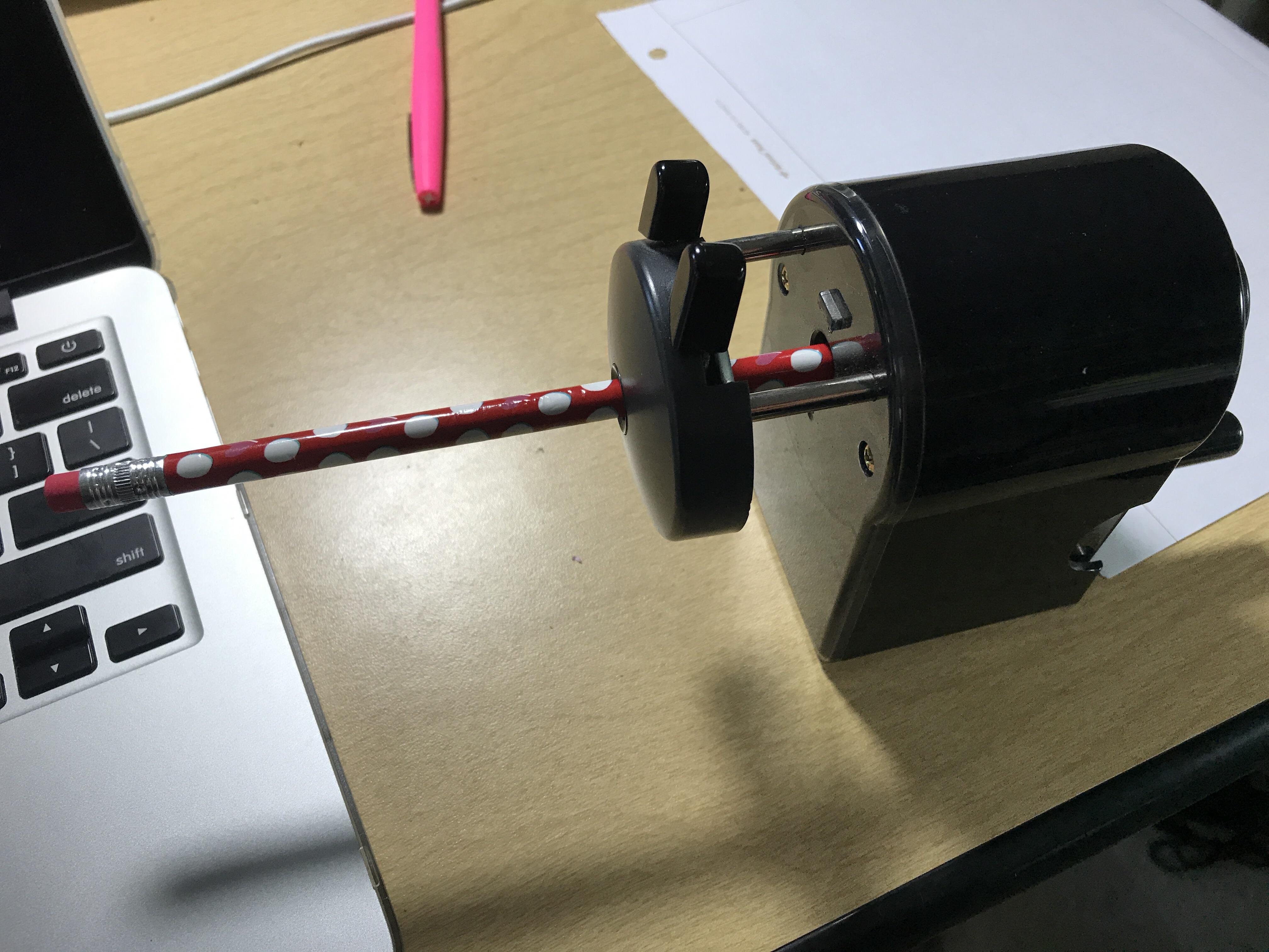 Japanese pencil sharpener with a mechanism to keep the pencil in while