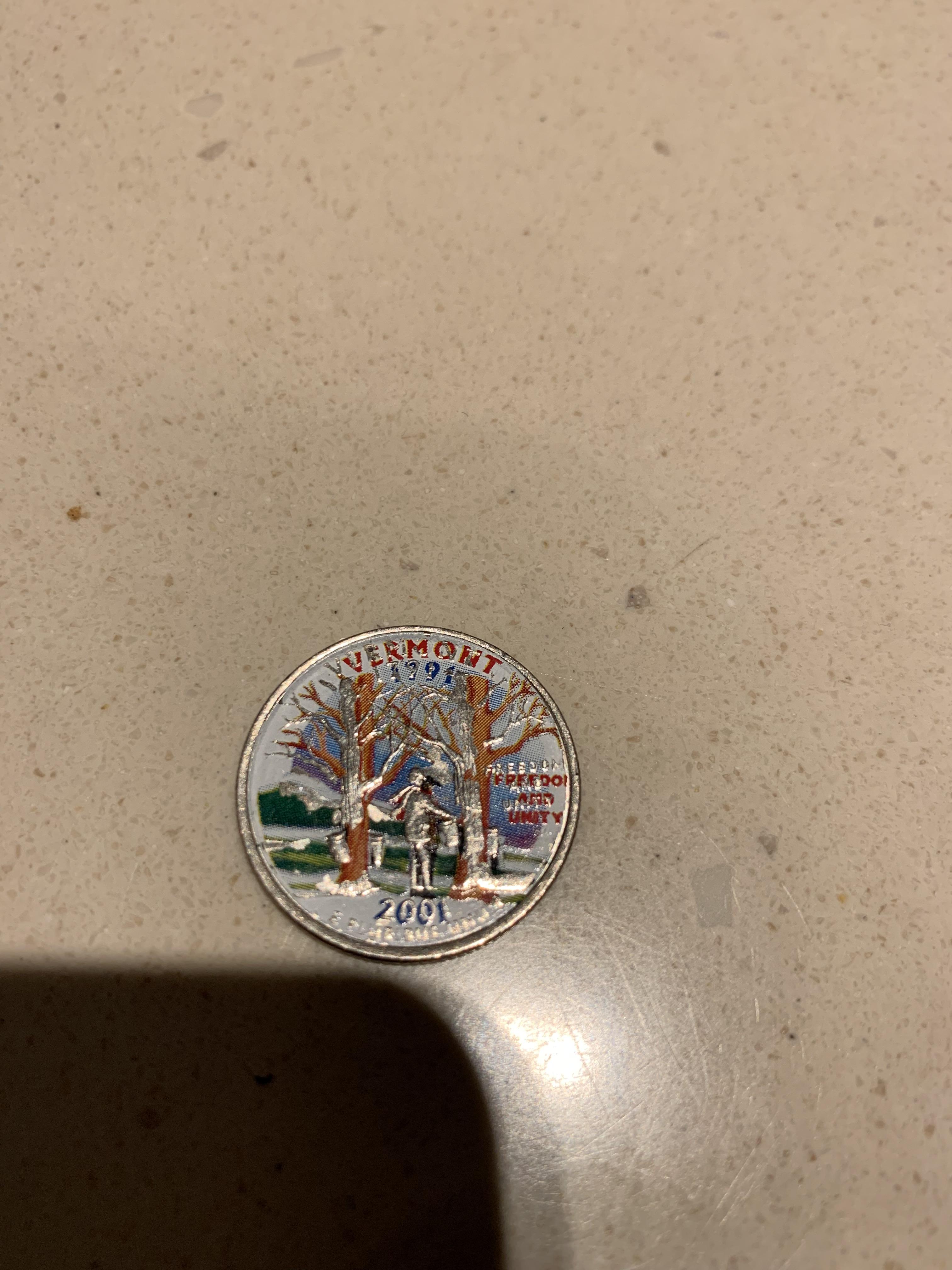 Painted quarter. Does not look like someone took the tine to paint over