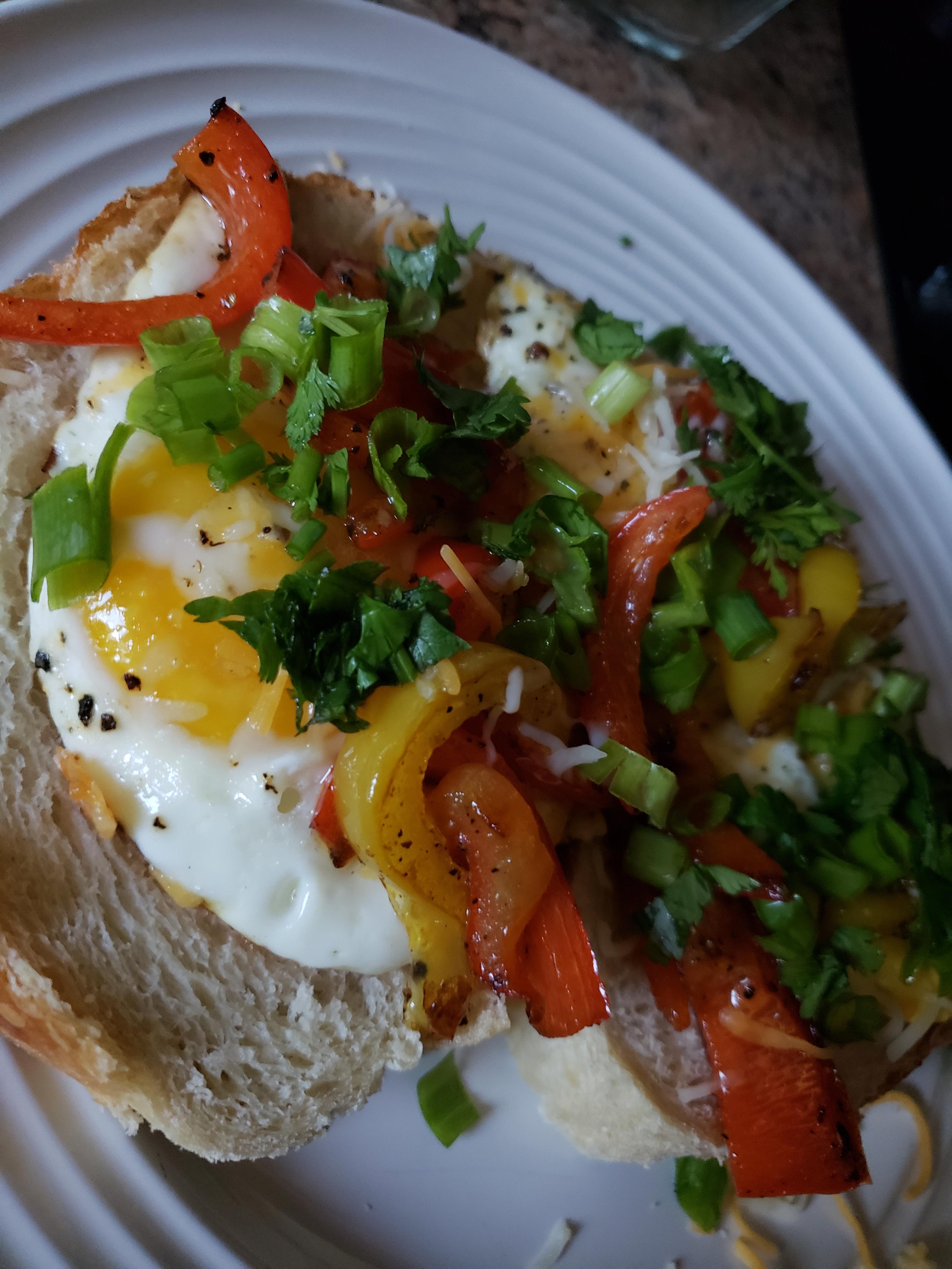 Eggs, bell peppers cilantro and cheese on sourdough bread [homemade