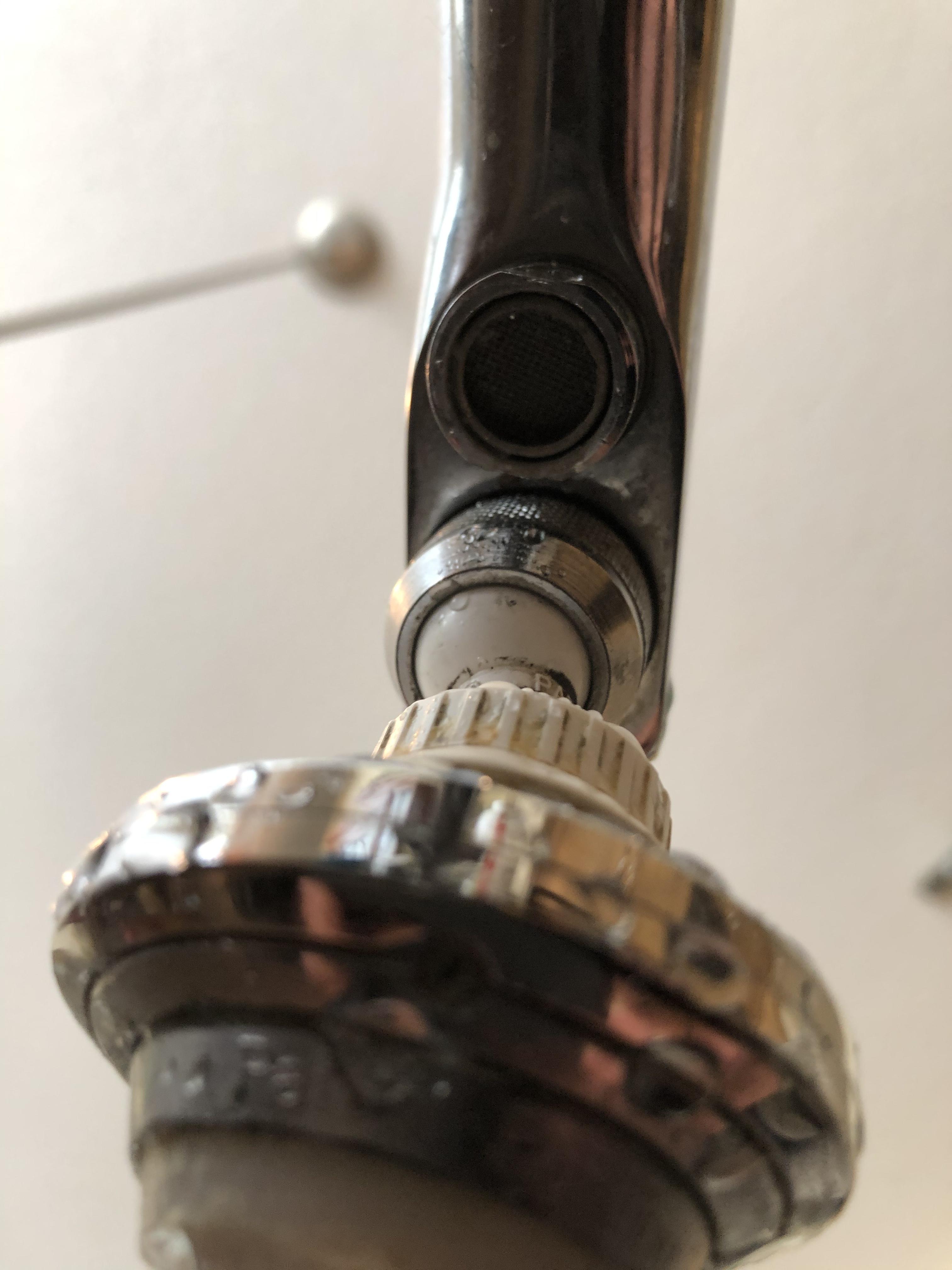 What is this little hole behind the faucet on my kitchen faucet that