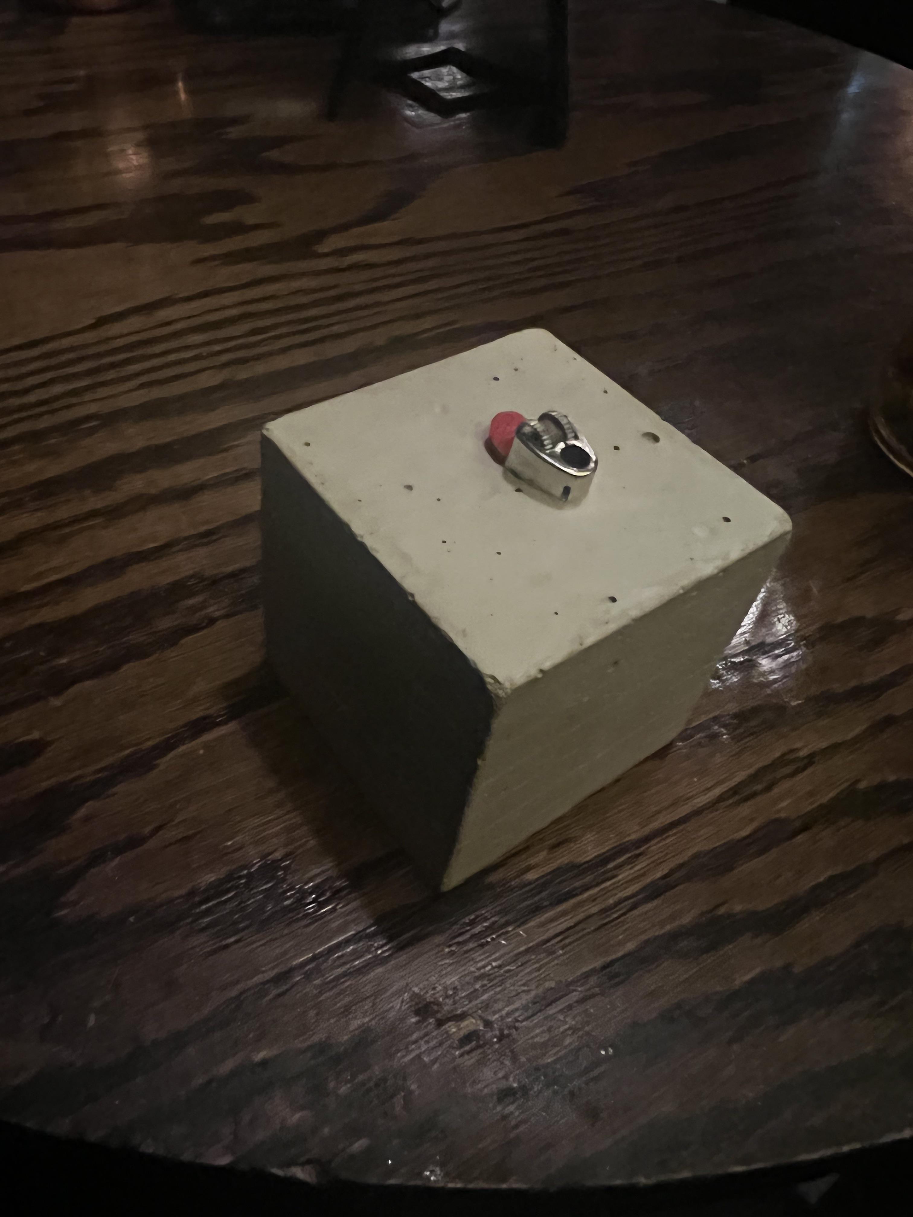 This lighter I was given, encased in cement. r/mildlyinteresting