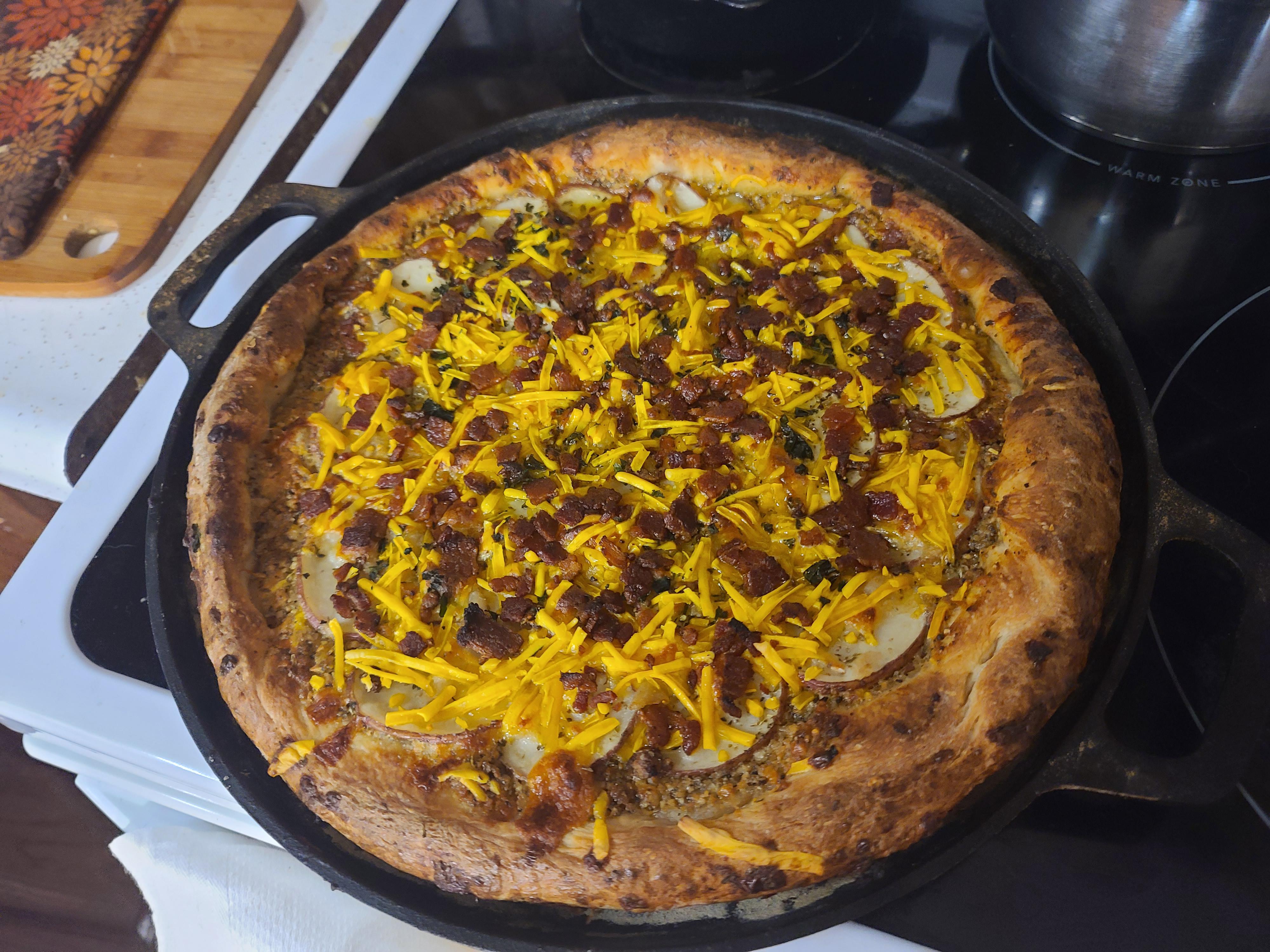 Baked potato pizza with peppercorn parmesan sauce and black garlic egg