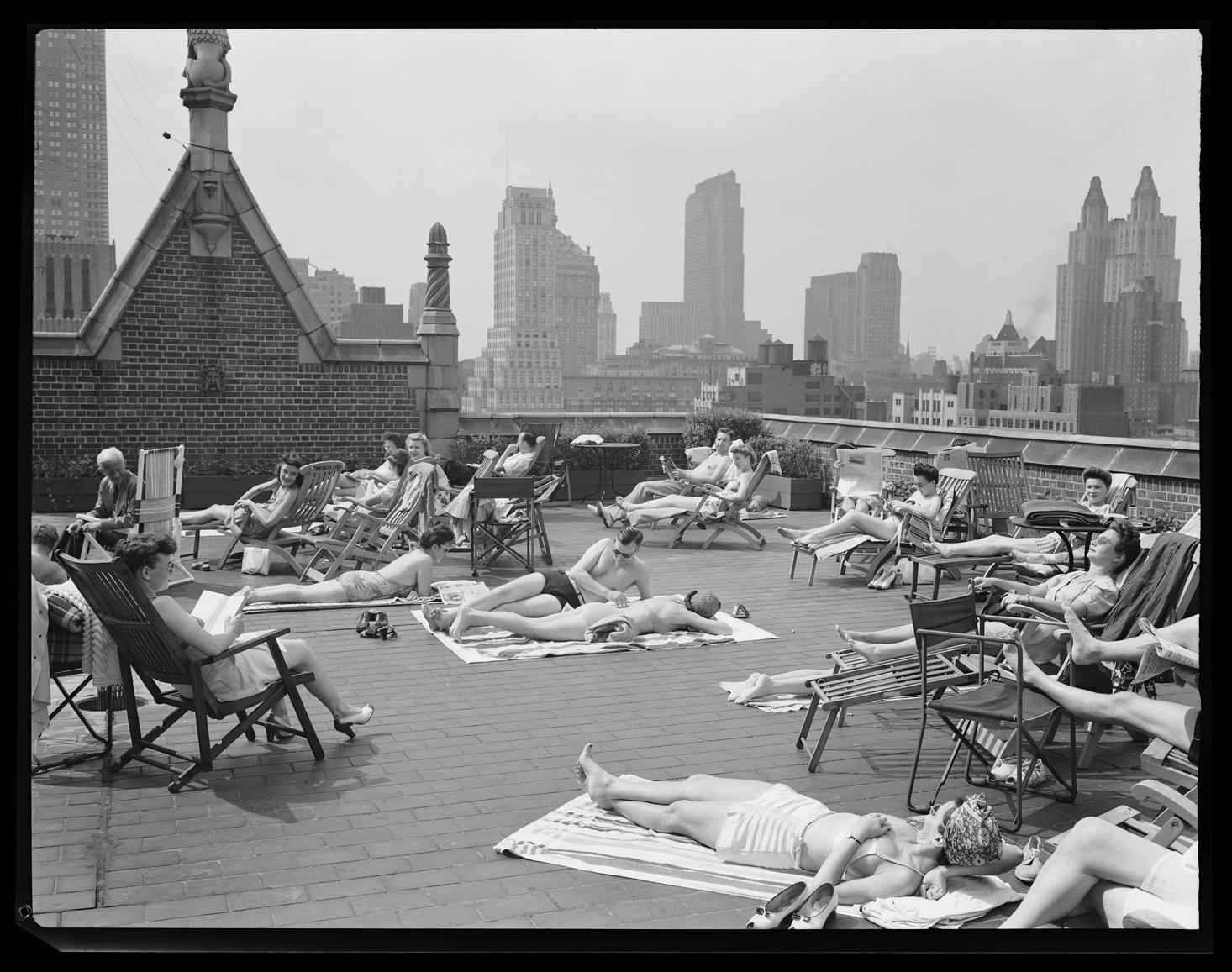 Sunbathing on the roof of an apartment building in Tudor City, New York
