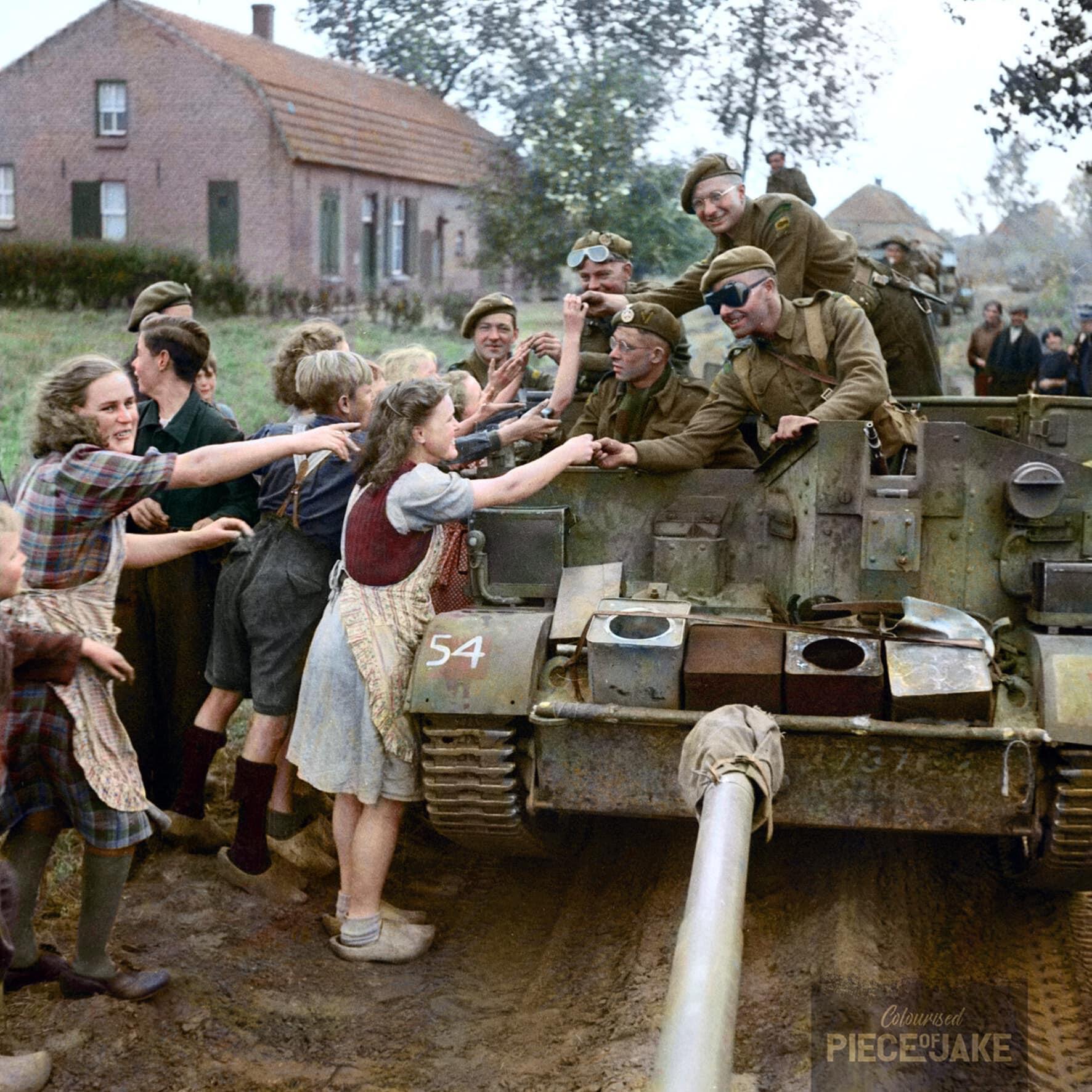 76 years ago today Universal Carrier crew of the 8th Battalion hands out chocolate to Dutch
