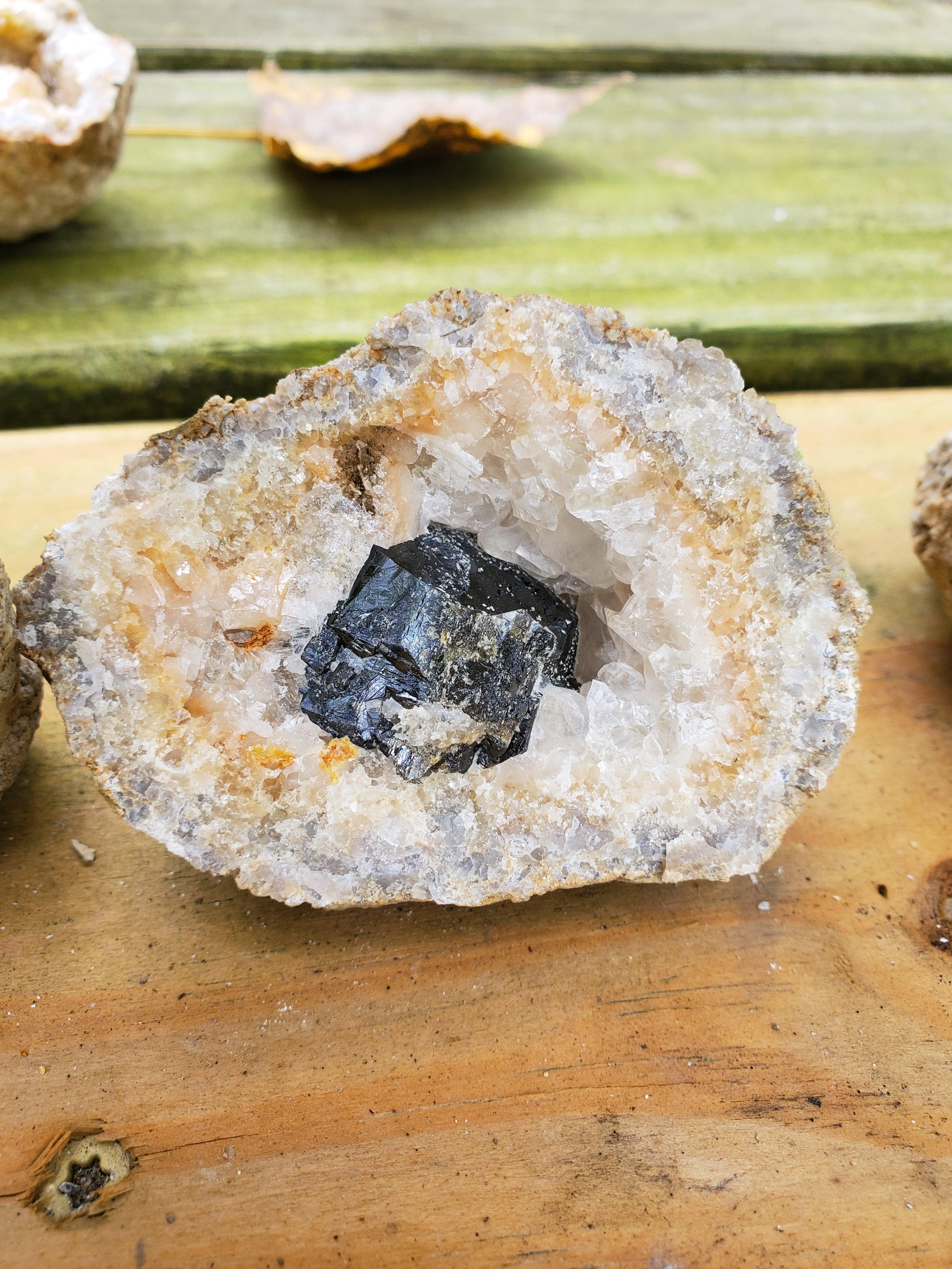 This is a Keokuk geode. Does anyone know what the shiny black bit is? I