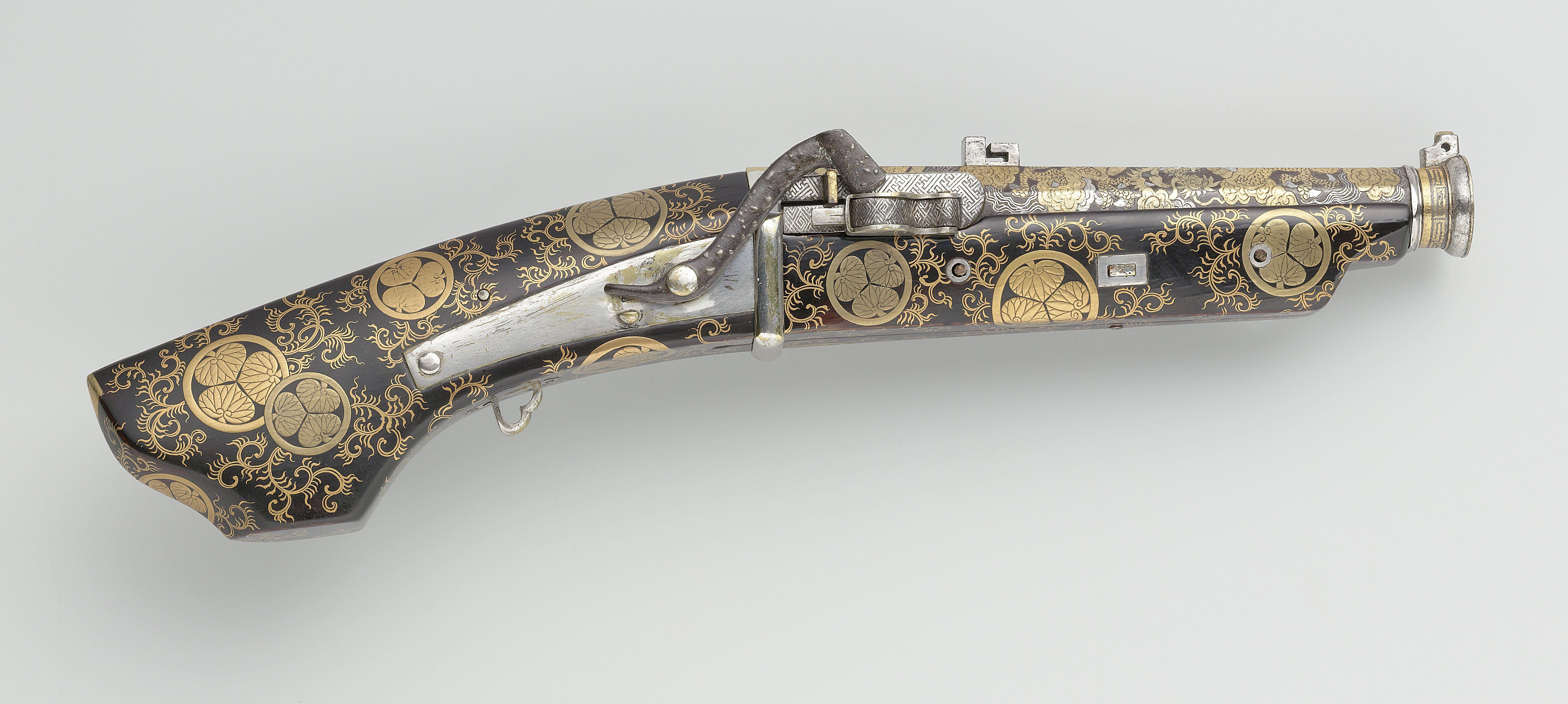 A pistol, richly decorated in gold and silver with Tokugawa mon, a