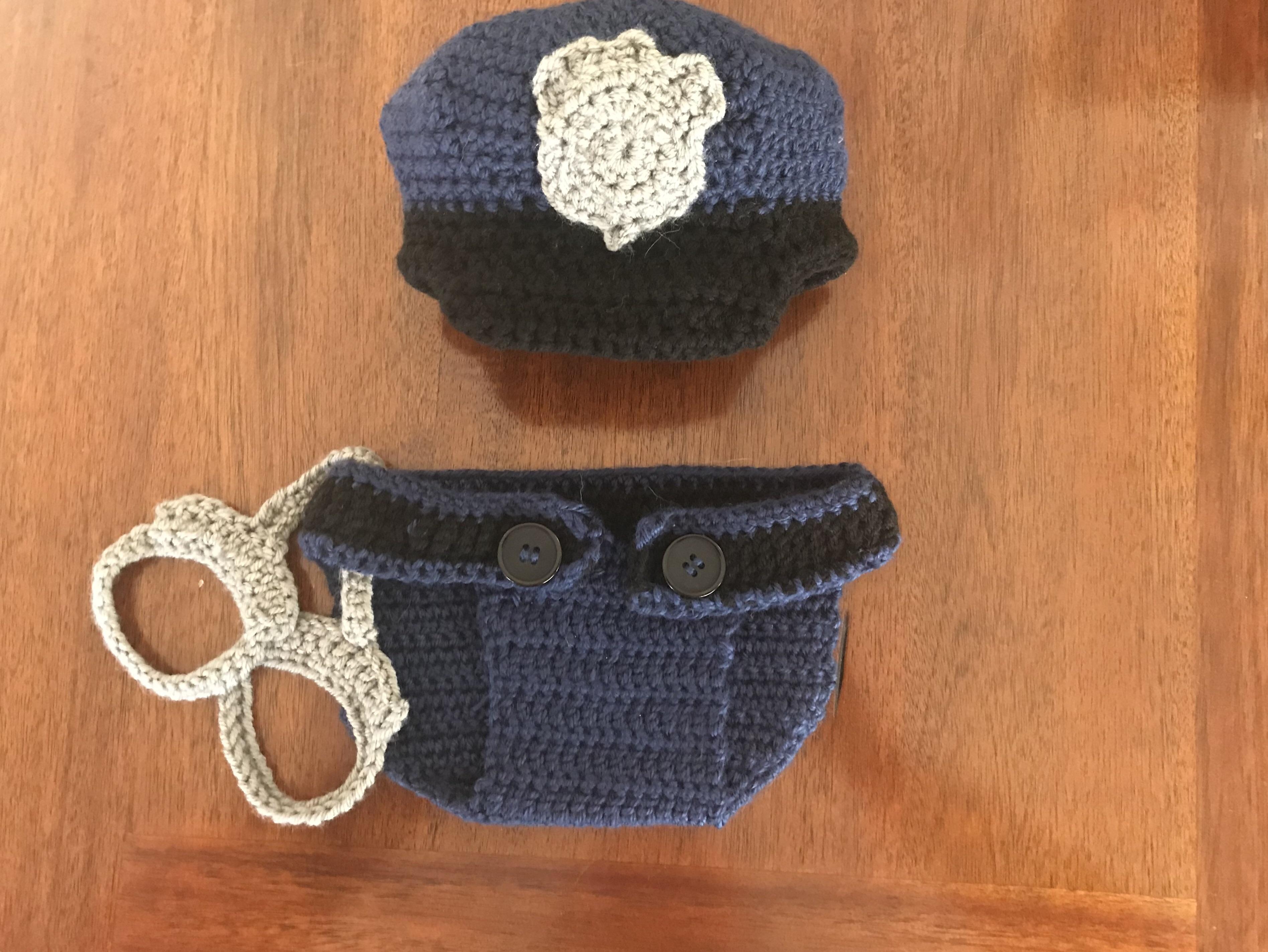 I crocheted this little outfit for the newborn baby of two police
