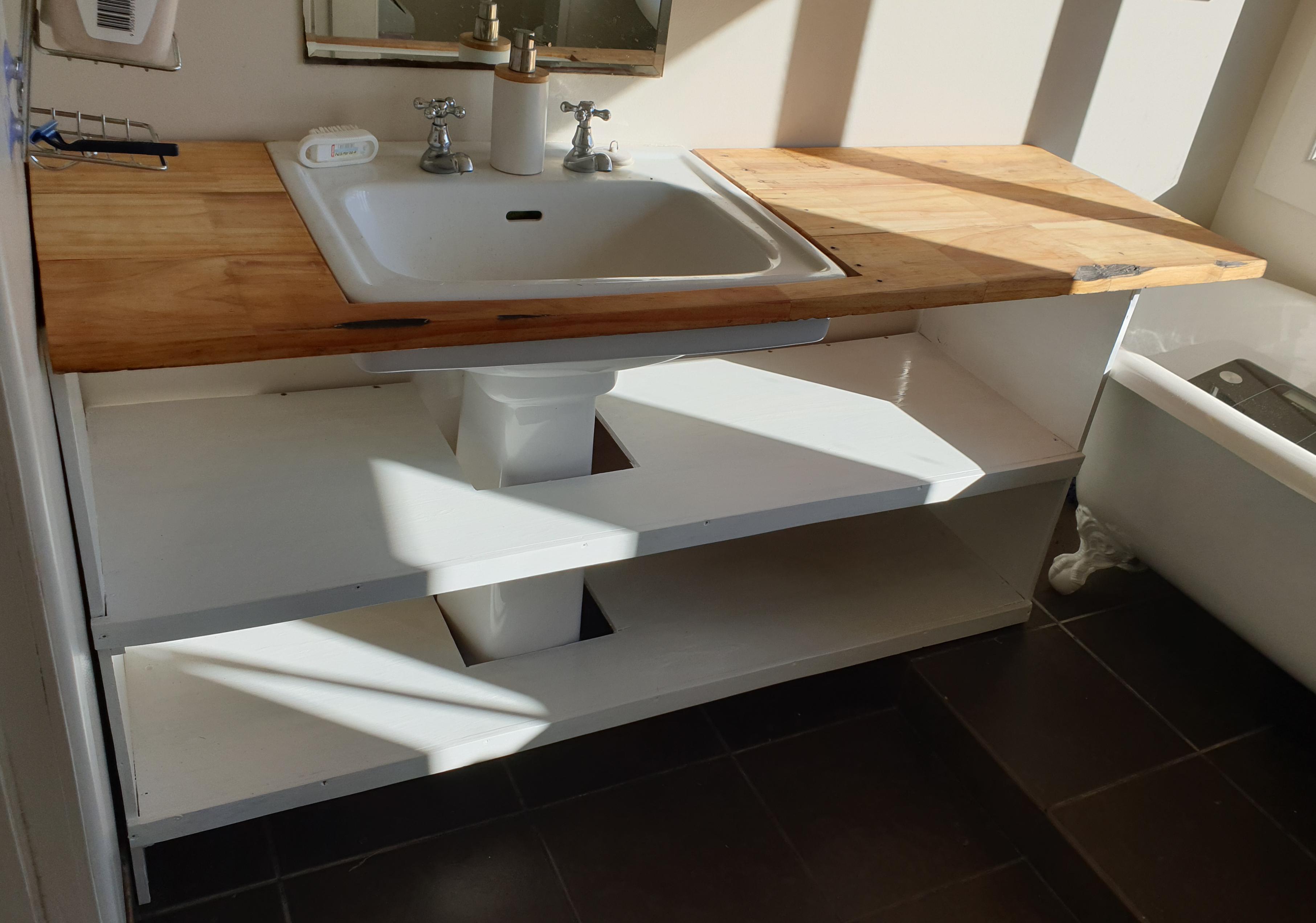 Made a vanity/shelving unit for bathroom out of an old pig house and