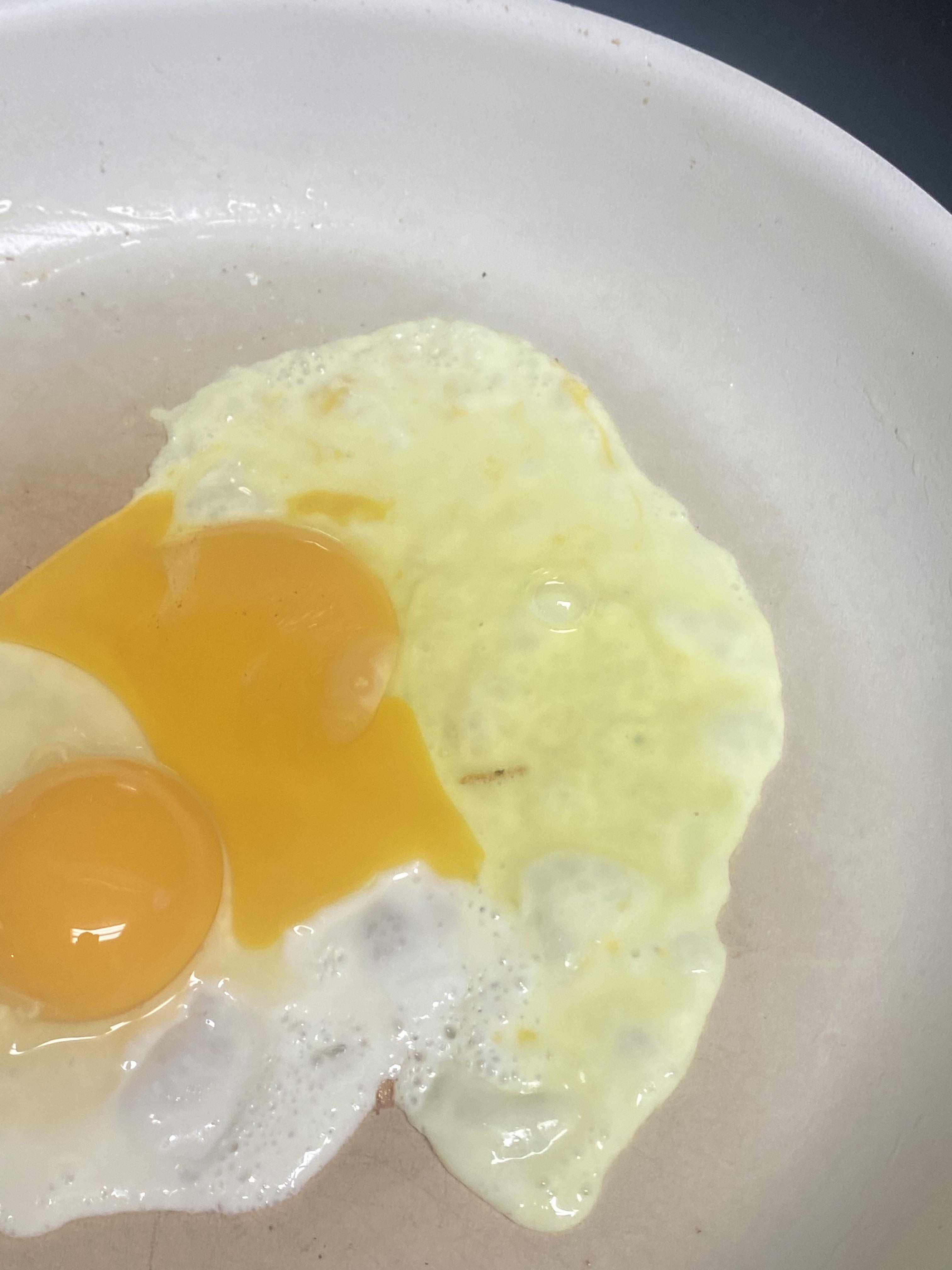 The egg white of my egg was neon green. r/mildlyinteresting
