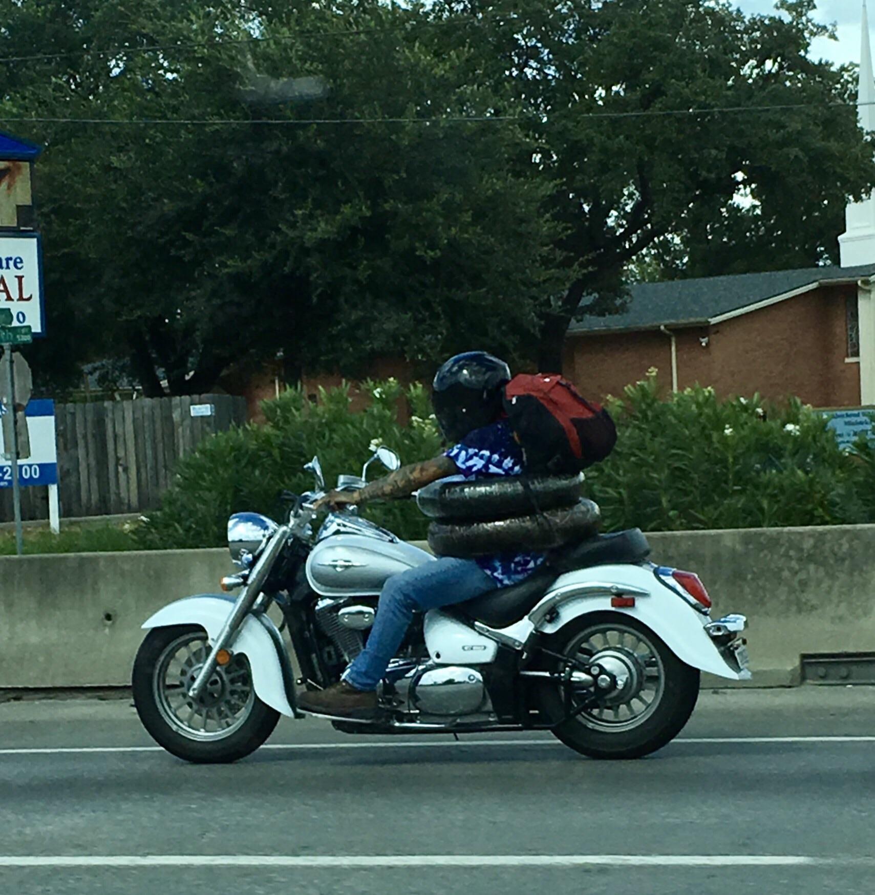 This guy carrying his motorcycle tires around his waist. r/houston