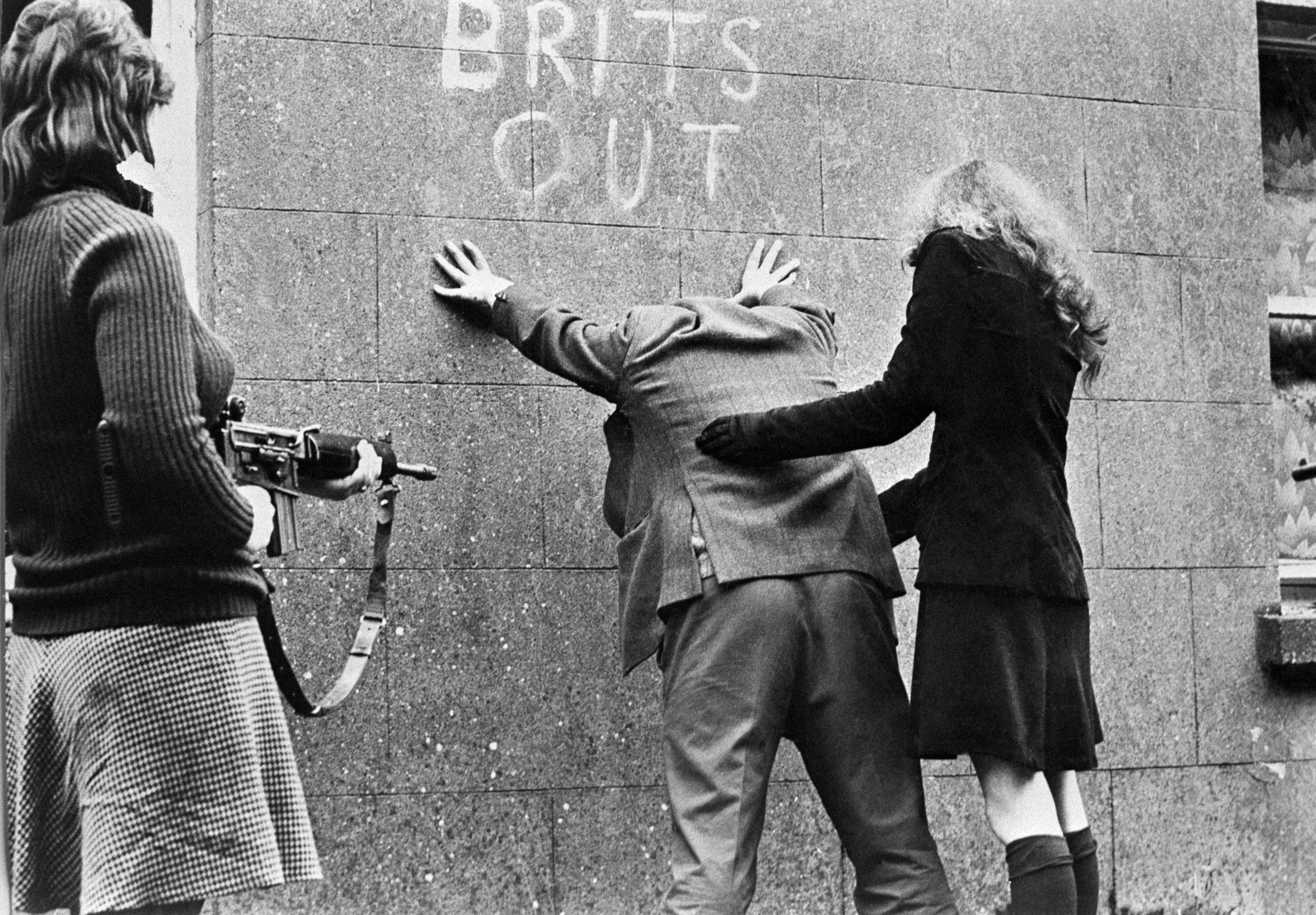 Female fighters of the I.R.A. search a man in Belfast, Northern Ireland