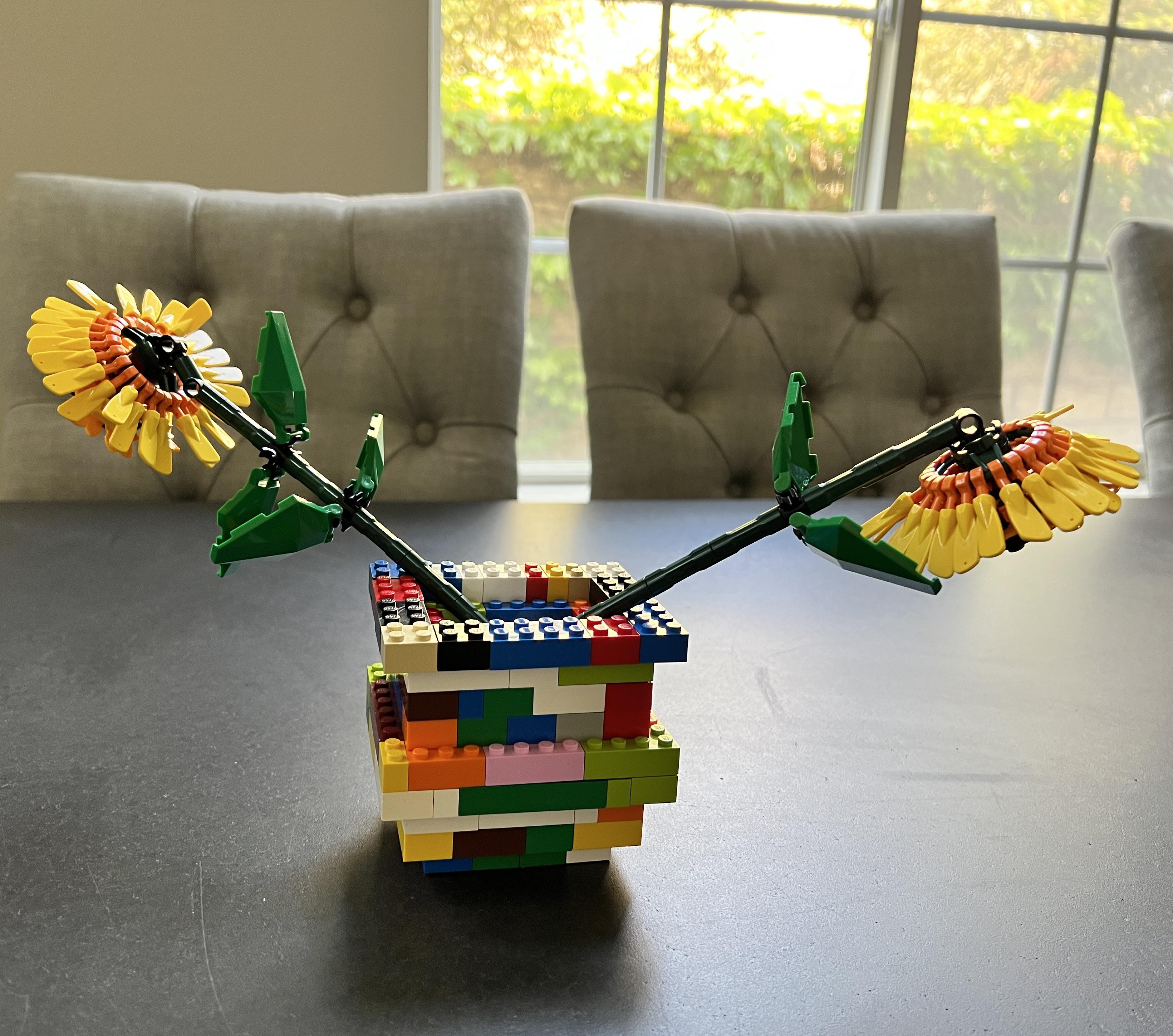 My 7YO son made a Lego vase for his twin brother’s Lego sunflowers