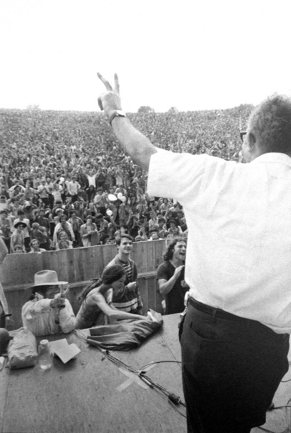 Martin Scorsese giving the peace sign to farm owner Max Yasgur at