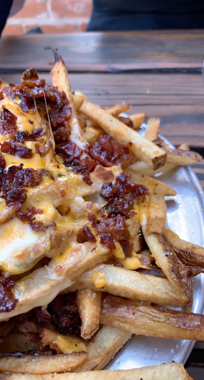 French fries fried in duck fat, melted cheddar on top, queso blanco in the center, with candied