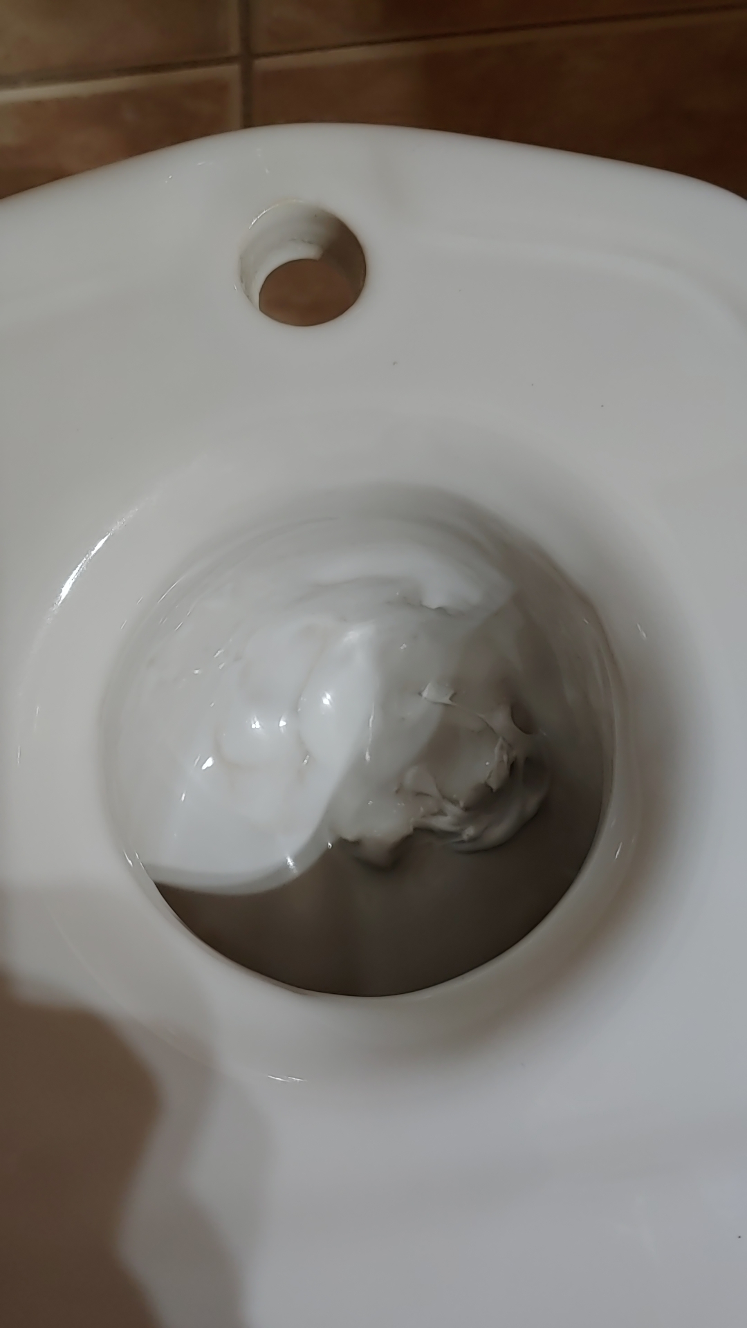 Bought two toilets, one seems okay but this one has caulk or something