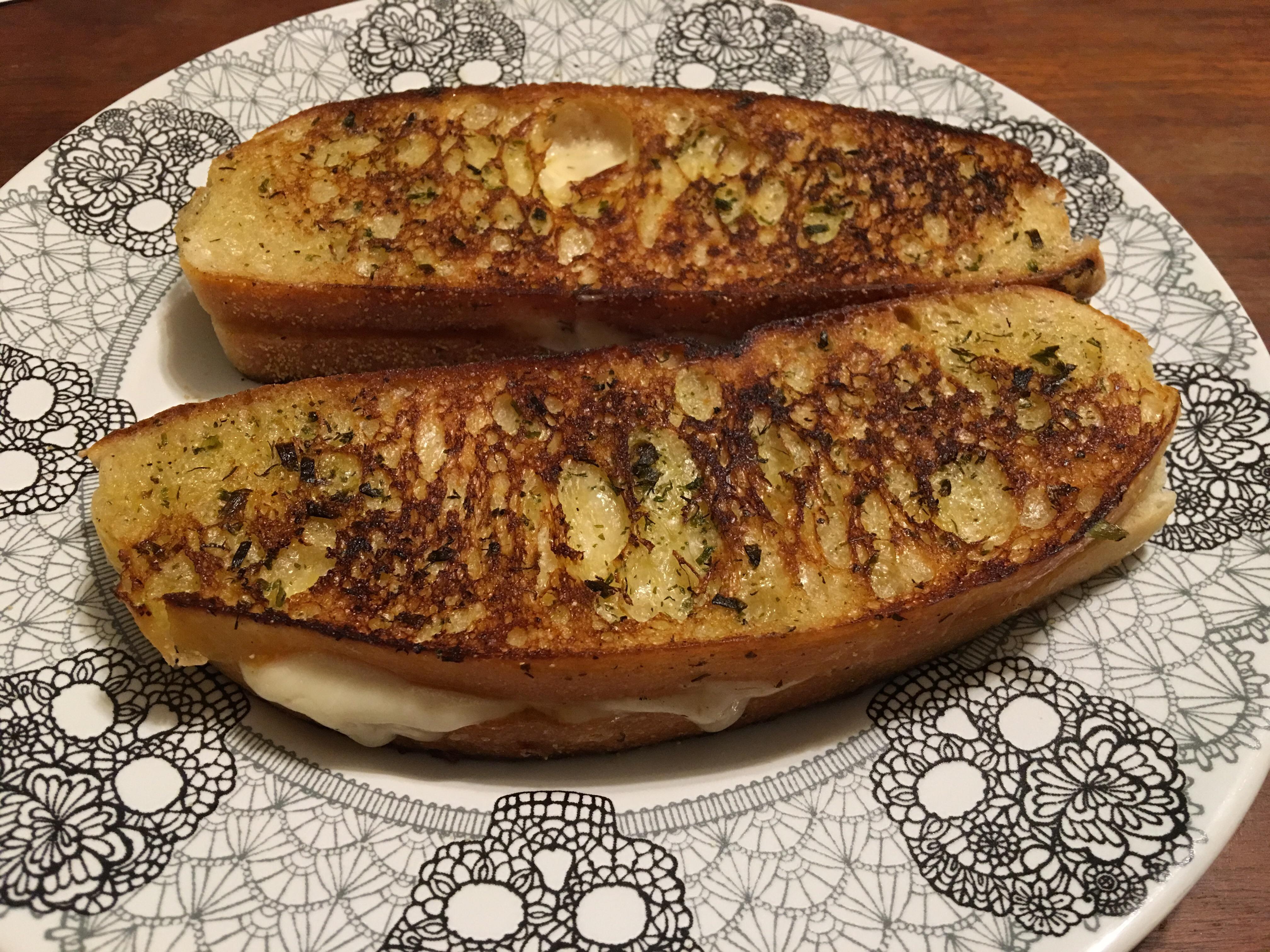 Cheddar and provolone on sourdough with lots of garlic and herb butter