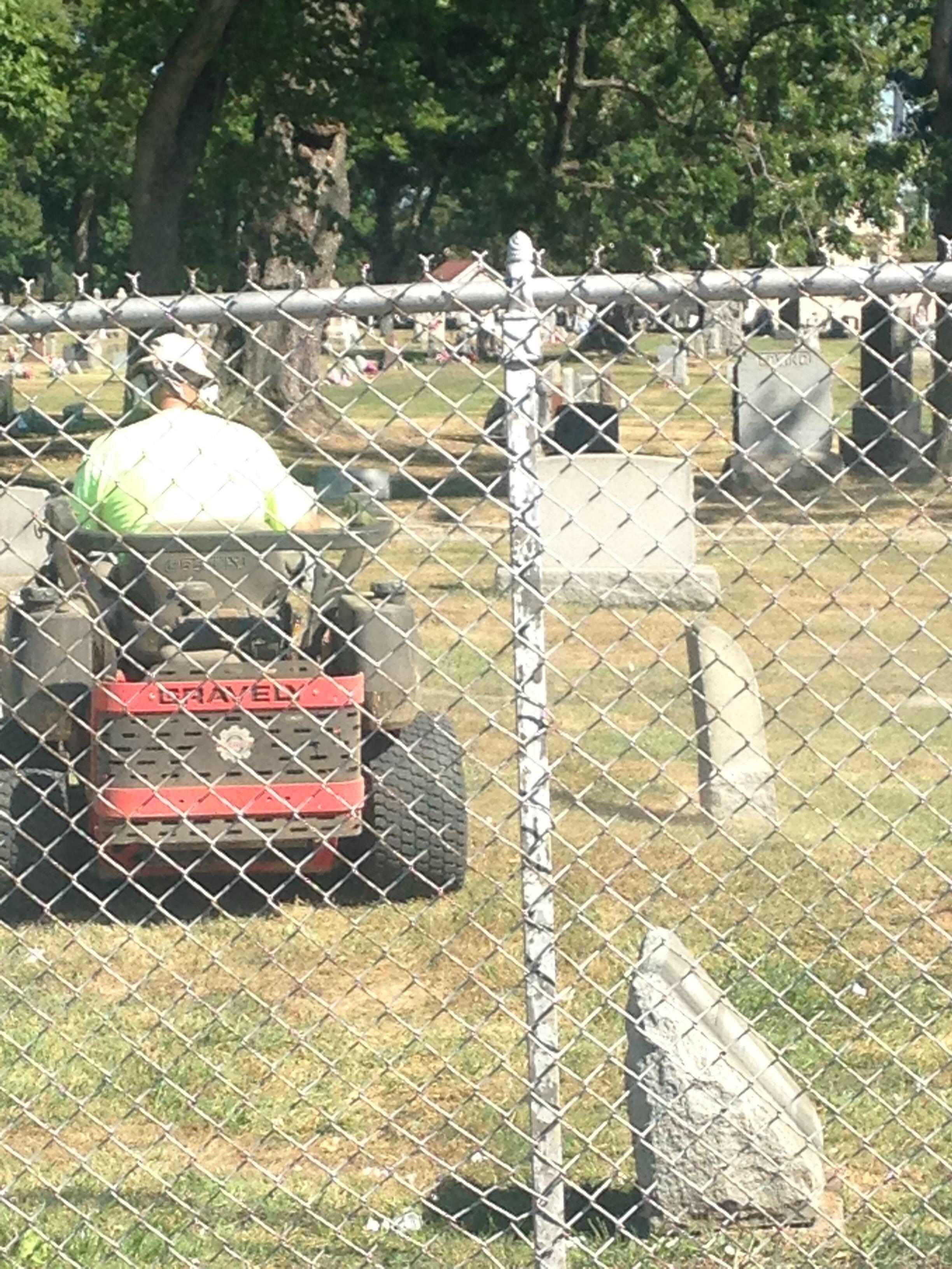 Gravely brand lawnmower mowing the lawn in a graveyard r