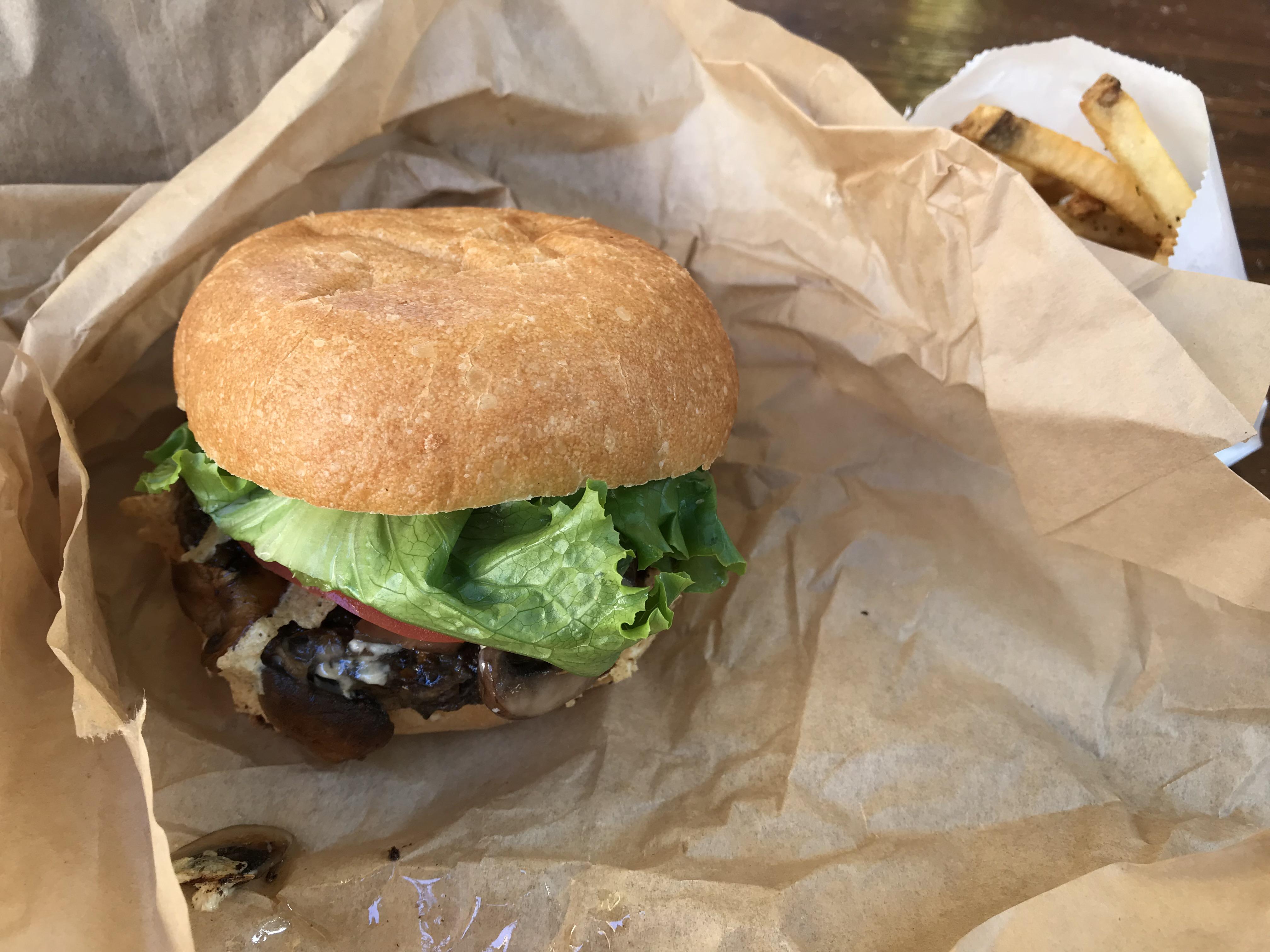 Delicious Temphe burger with Swiss cheese and mushrooms at Evolution in