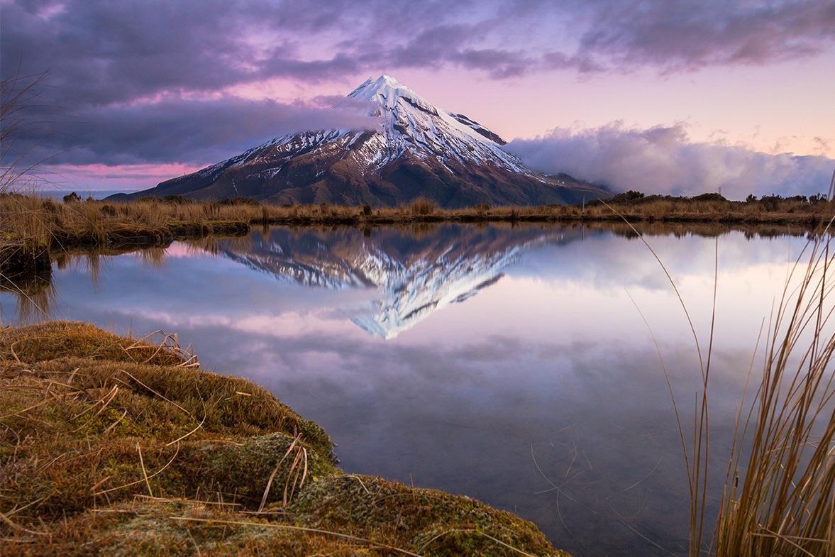 Mount Egmont/Taranaki is reflected perfectly in the still waters of