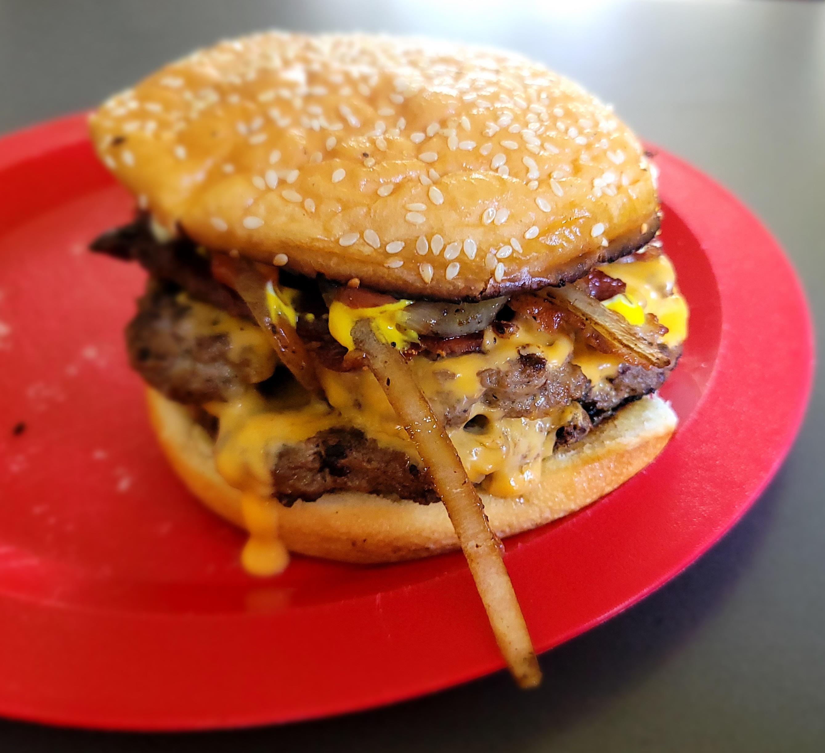 Smash burgers with grilled onions and bacon on our Blackstone. r/blackstonegriddle