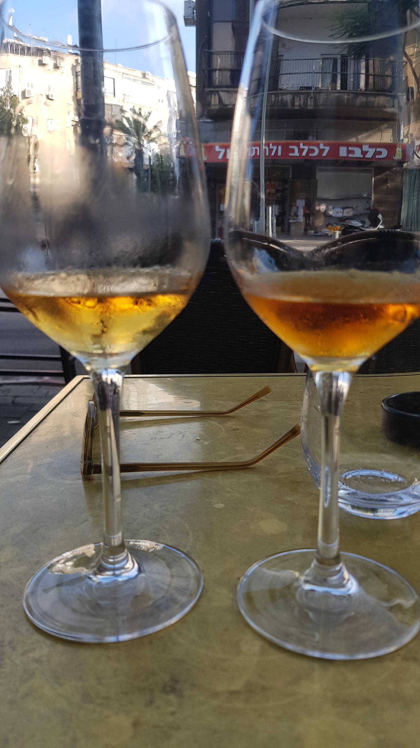Two different natural wines.were sitting on a corner in Tel Aviv watching the world go